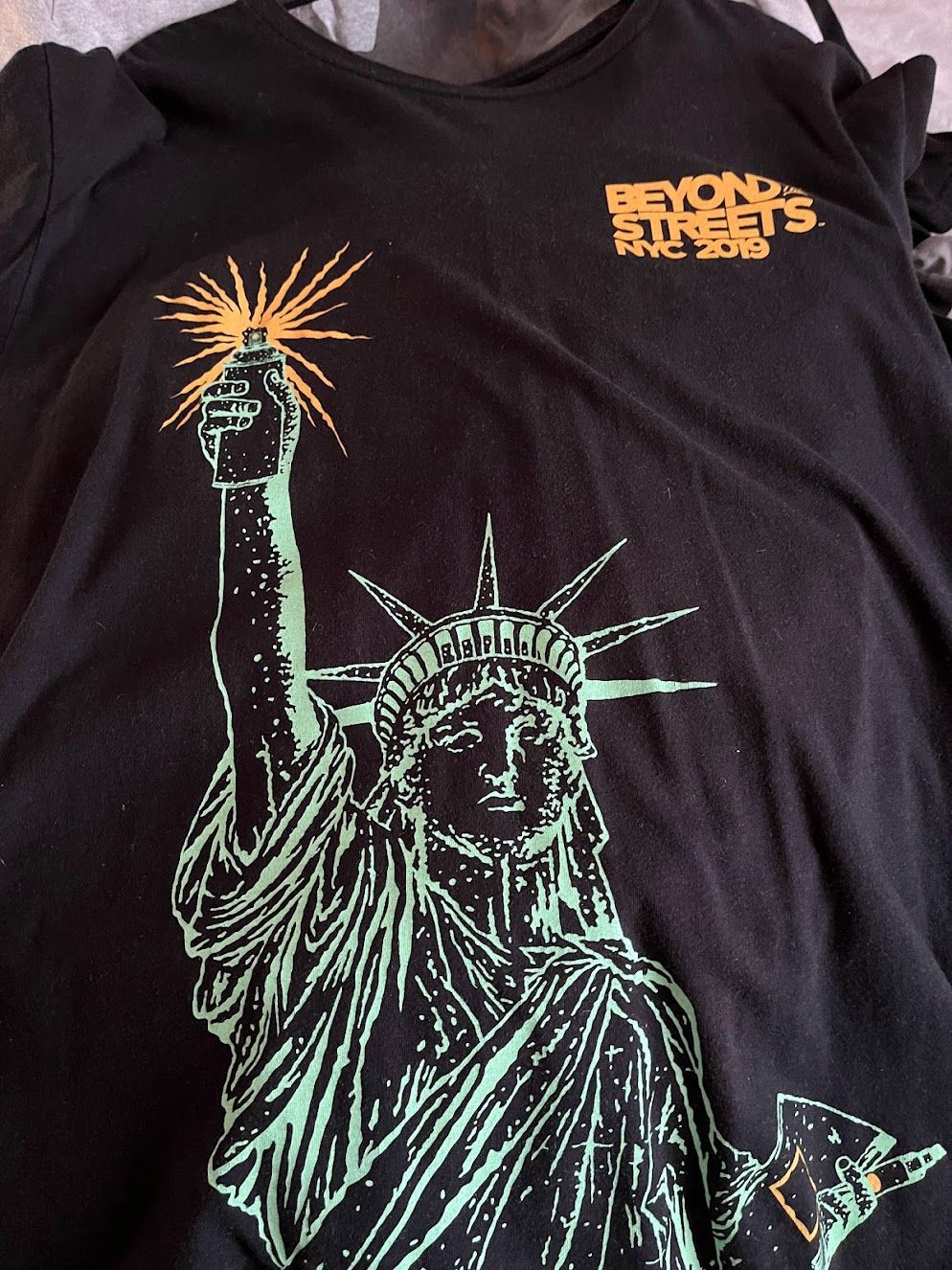 Statue of Liberty in graffiti t-shirt from Beyond the Streets exhibition