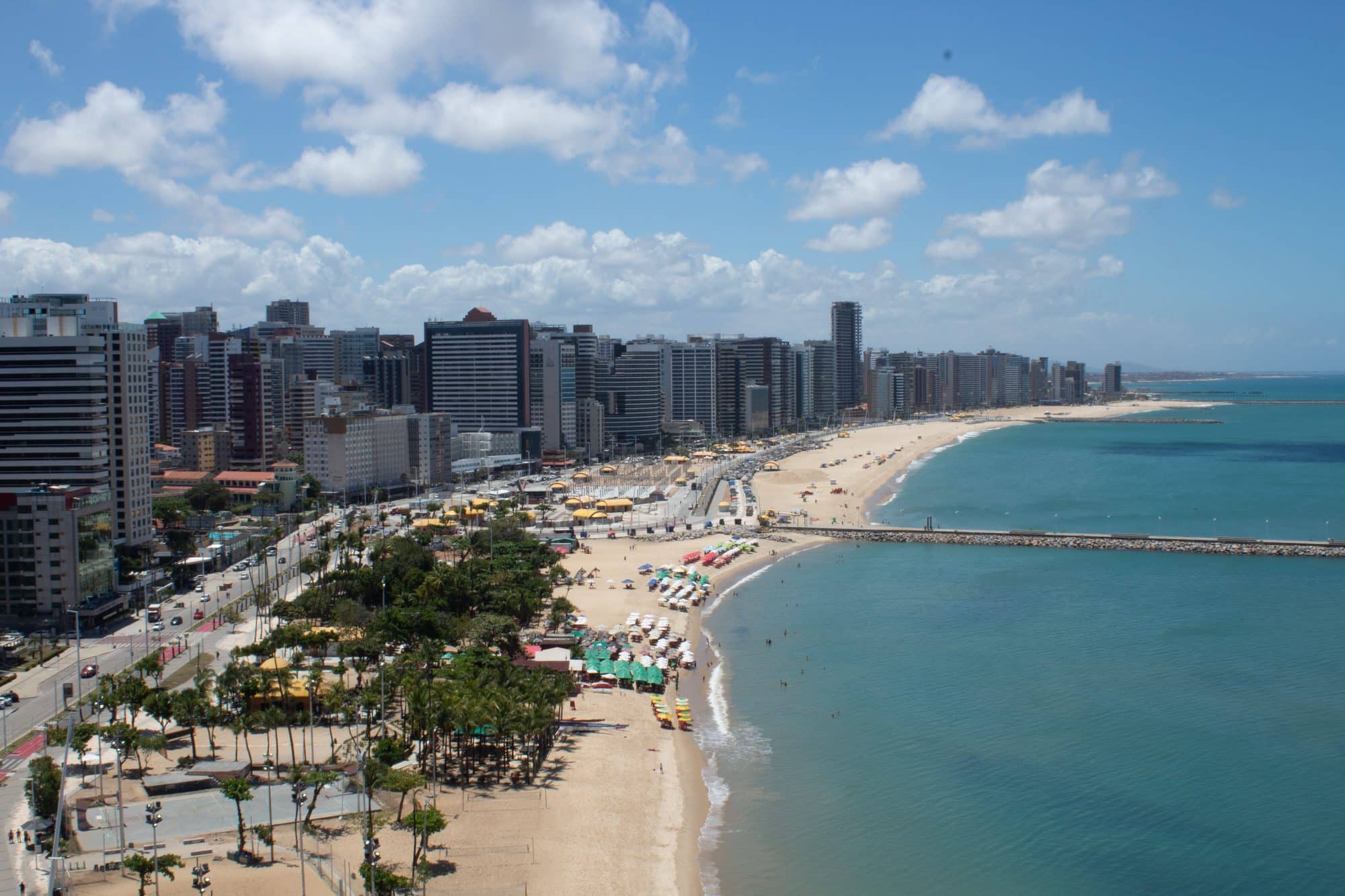 A beachfront street in Fortaleza, Brazil - Avenida Beira Mar with sandy stretch on one side and high-rise buildings on the other. 