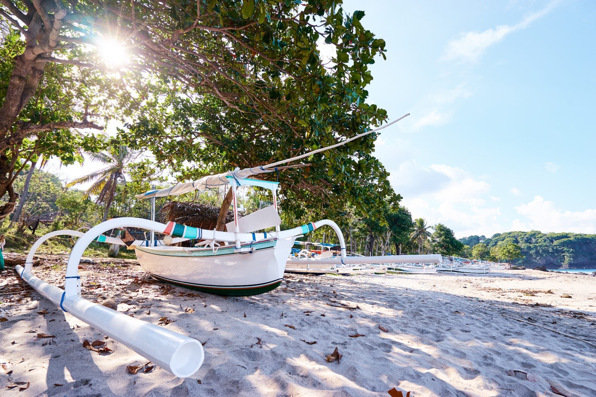 Beautiful landscape. Ocean beach and indonesian fishing boats.