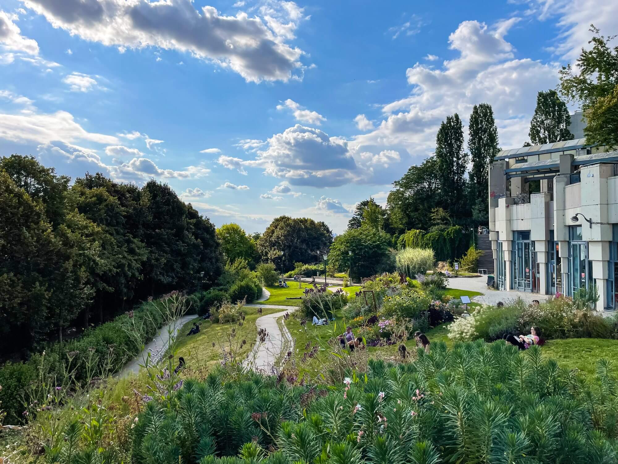 A green landscaped garden and a manor house in the Belleville Park, Paris