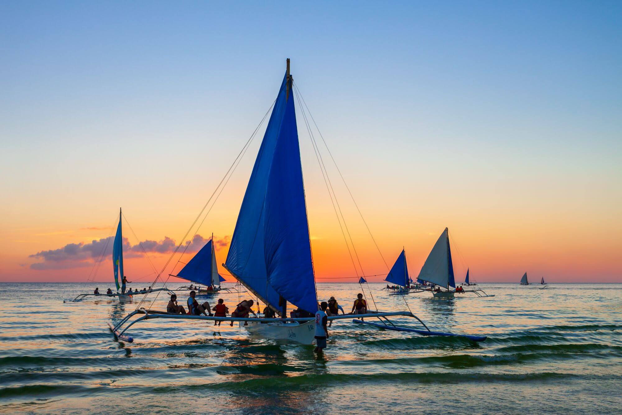 A beautiful sunset on Boracay Island - people in the boats enjoying the setting sun. 
