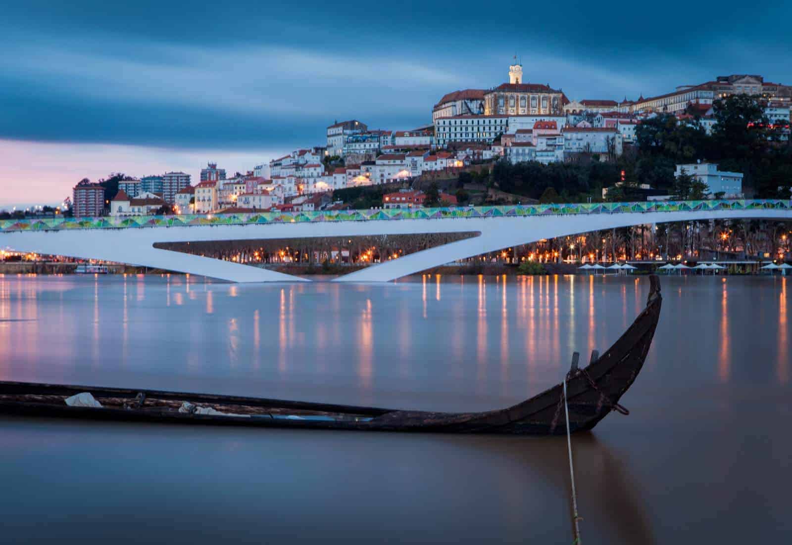 An old elegant university building on to of the hill in the dusk across the river