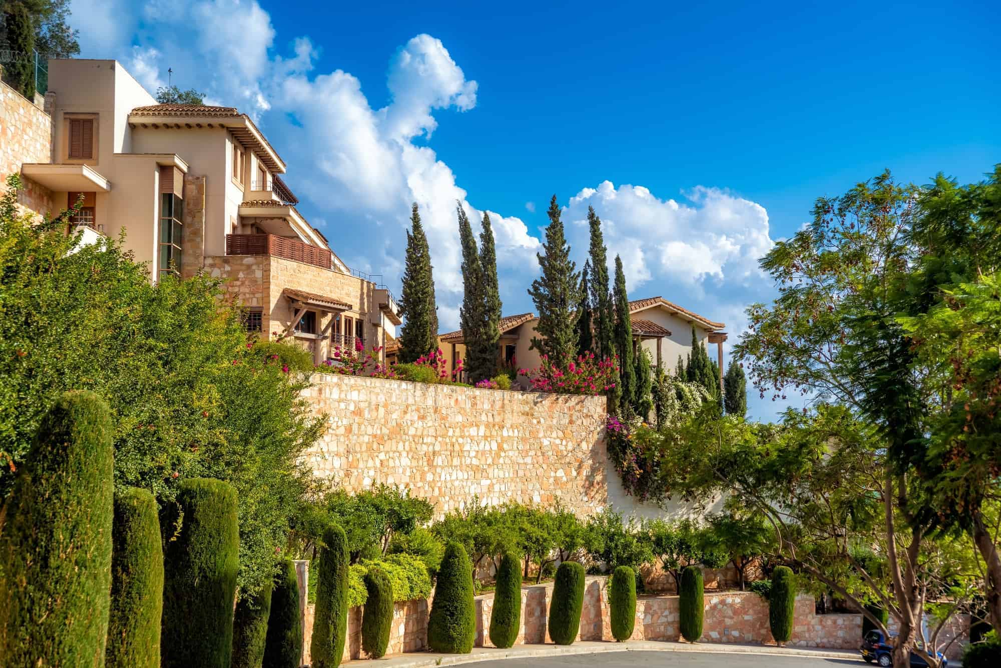A village street in Cyprus, a sand stome wall of the garden and blooming trees