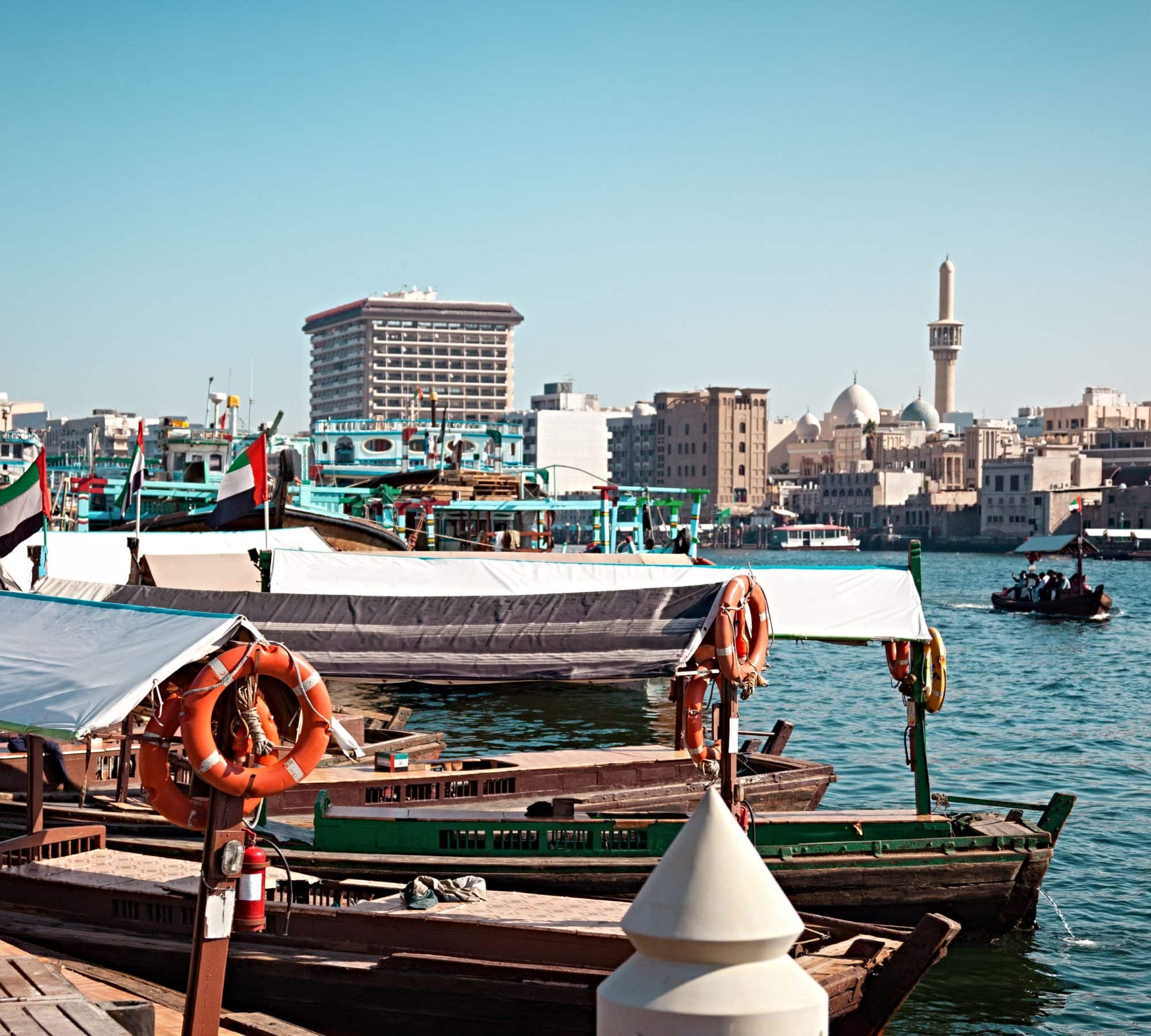 A waterfront in Dubai with taxi boats