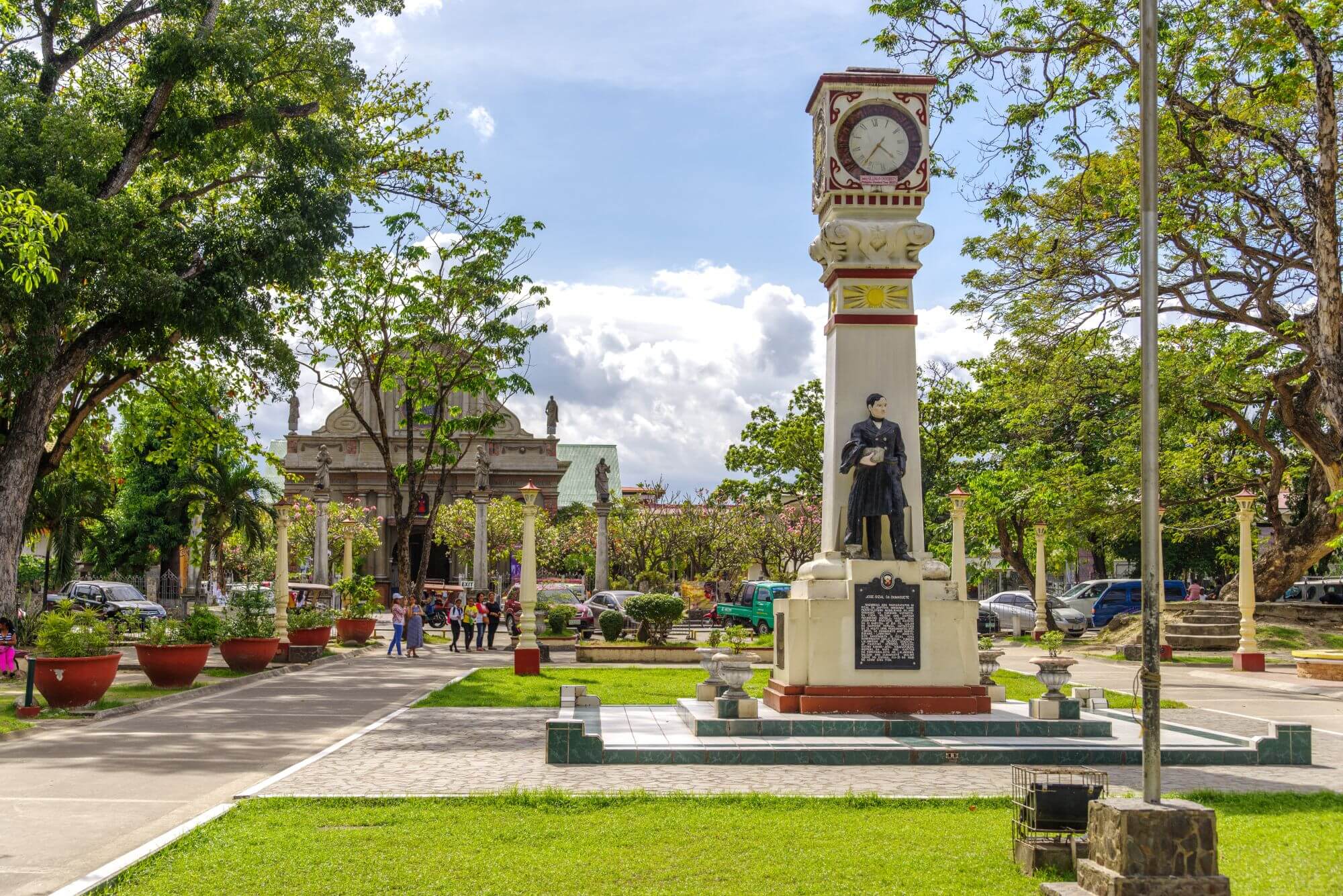 A city park with a monument in the center in Dumaguete, the Philippines