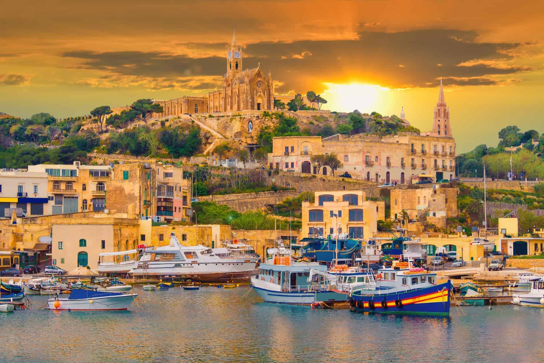Gozo island, medieval architecture of castle and boats on the harbor of Malta
