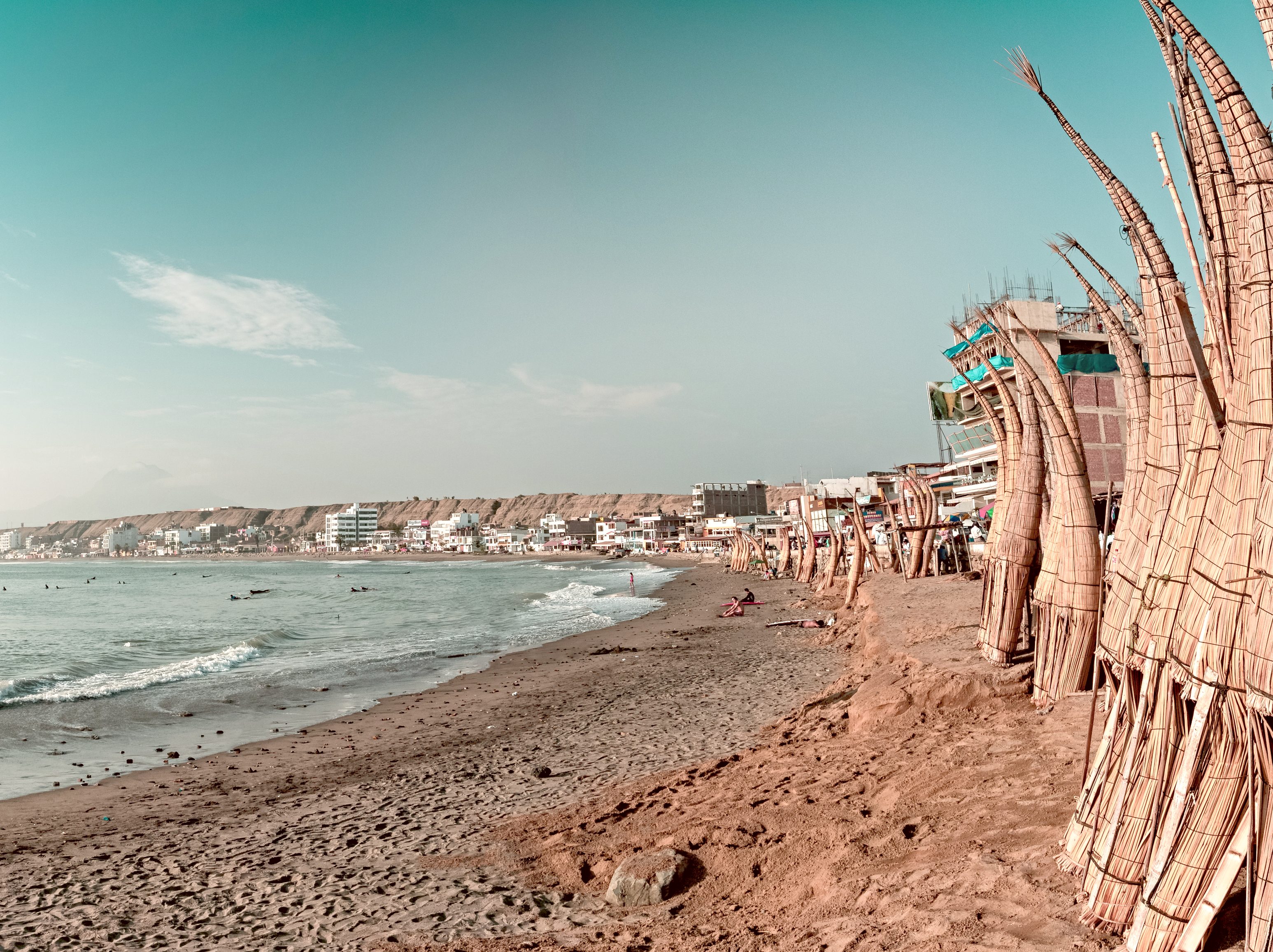 A beach in Huanchaco Peru ined with traditional reed boats