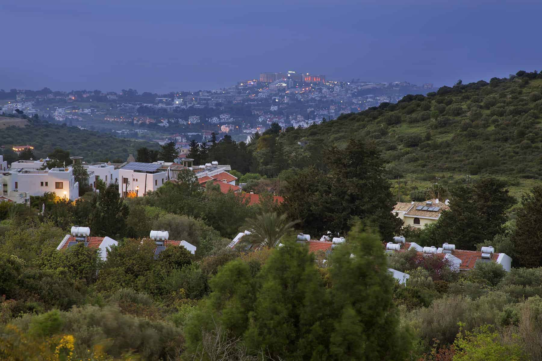 Traditional white-walled houses of North Cyprus villages in the mountains looking down to Kyrenia and the sea 