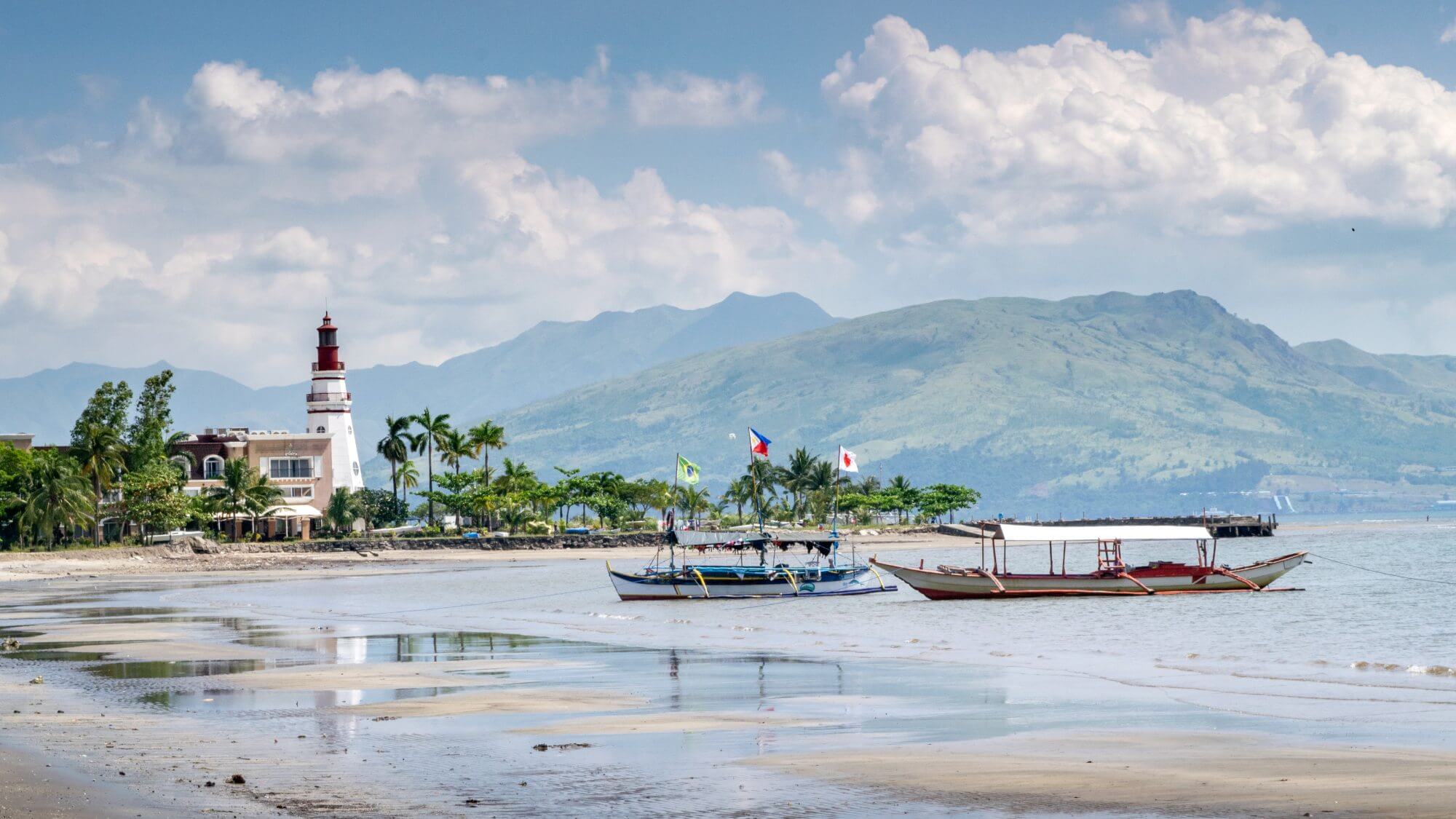 Subic Bay  - a lighthouse and mountains in the background