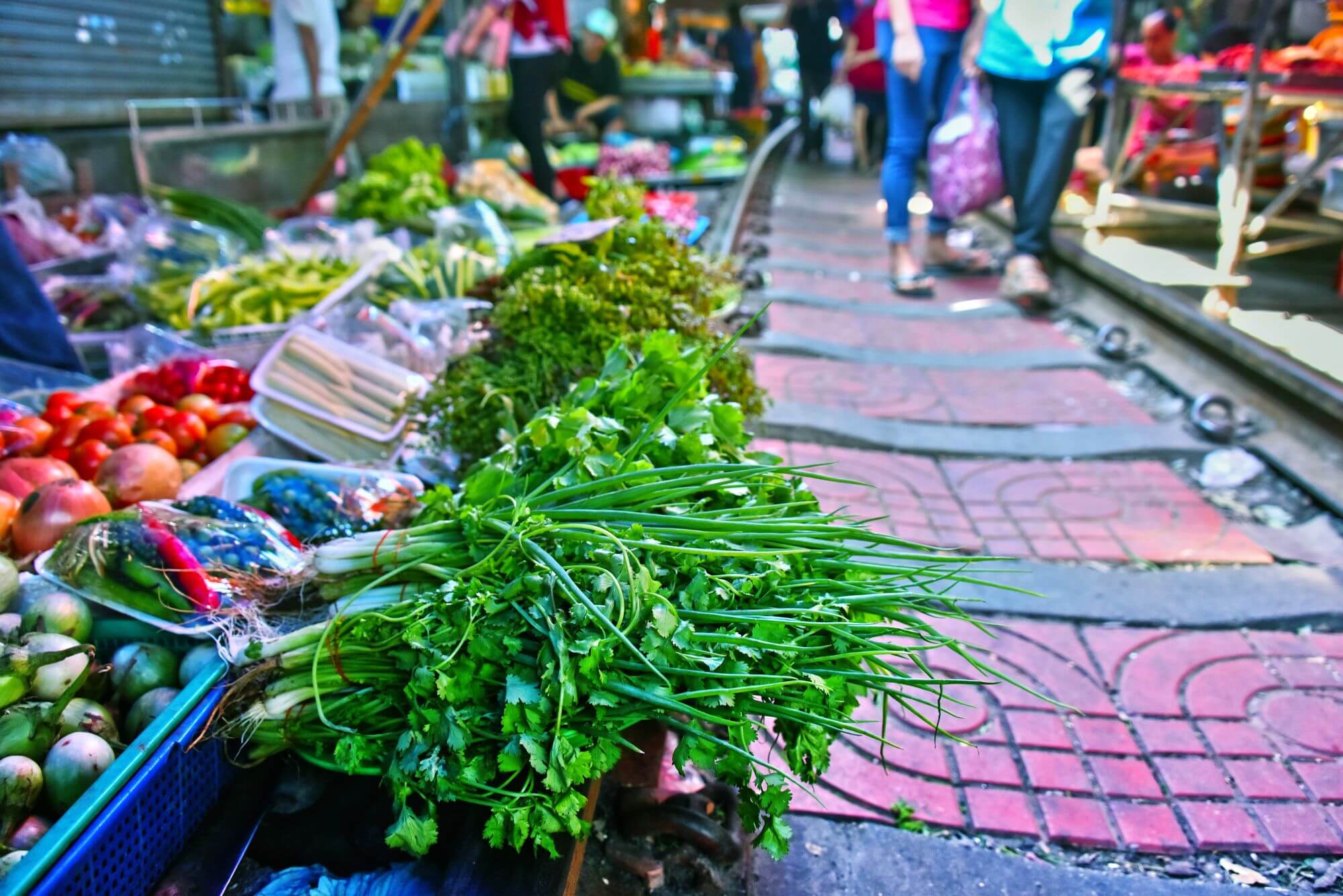 Colorful fruit and veg on the stalls of a sreet food market in Bangkok
