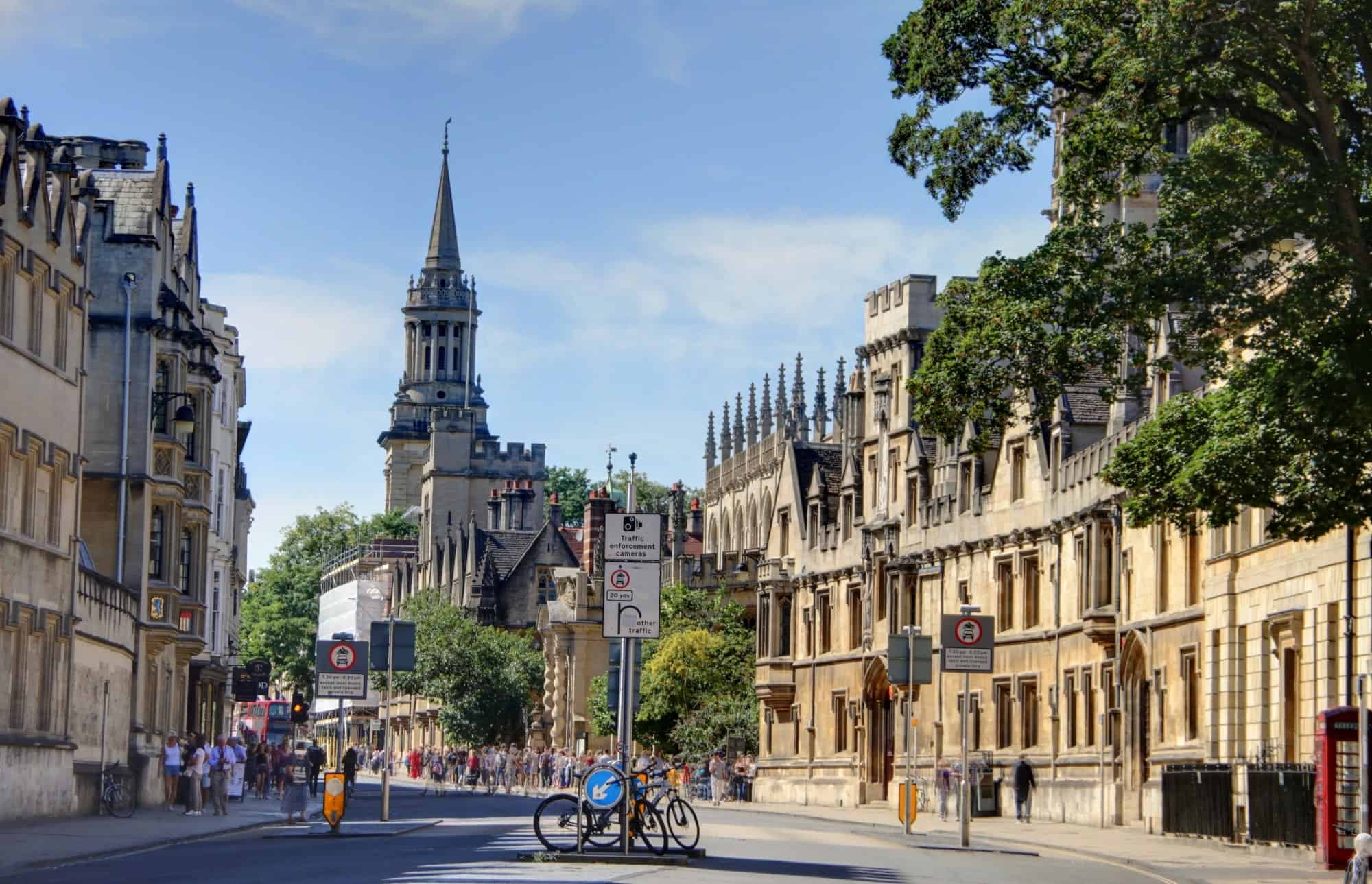 Oxford, historic buildings and tourists enjoying a sunny day.