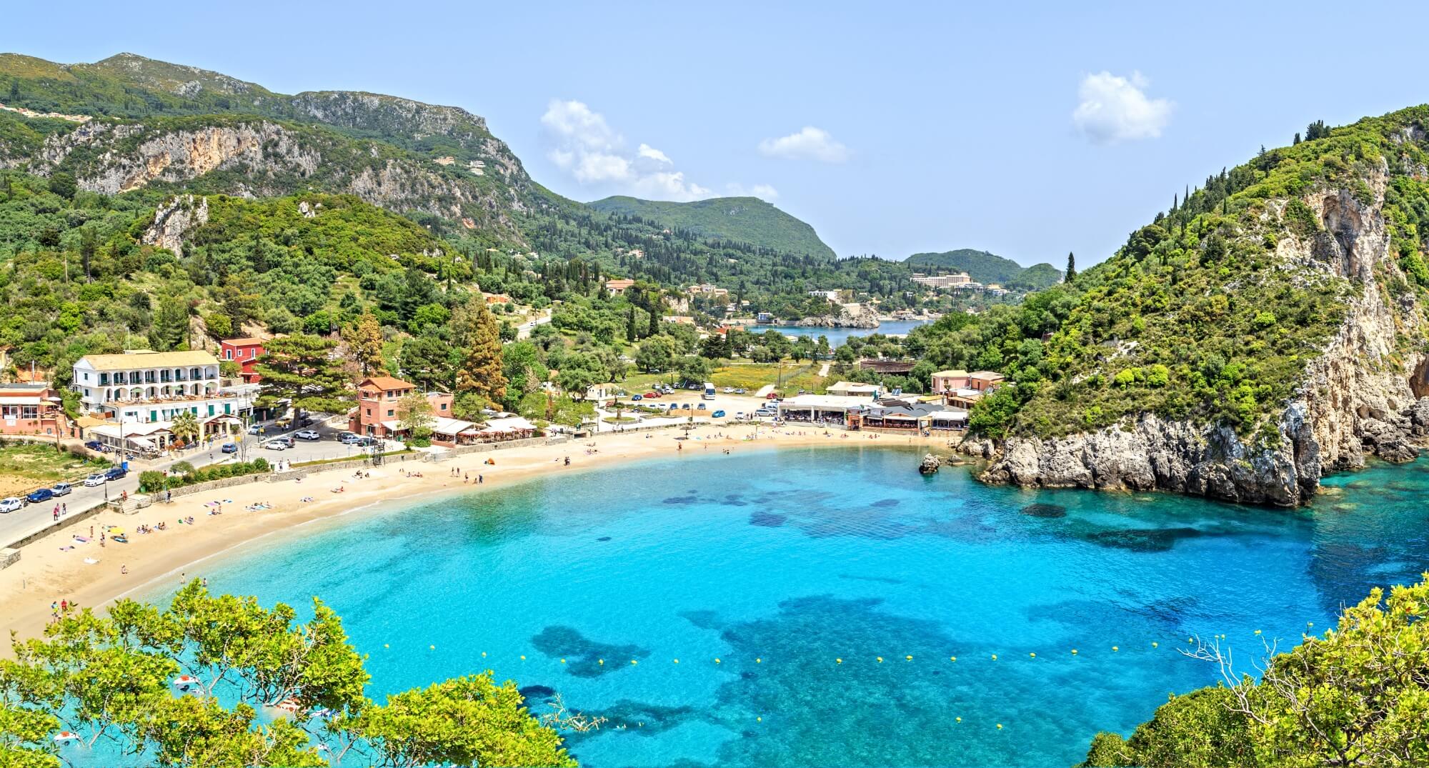 A small town llocated around a horse shoe shaped bay with blue waters, Corfu, Greece.
