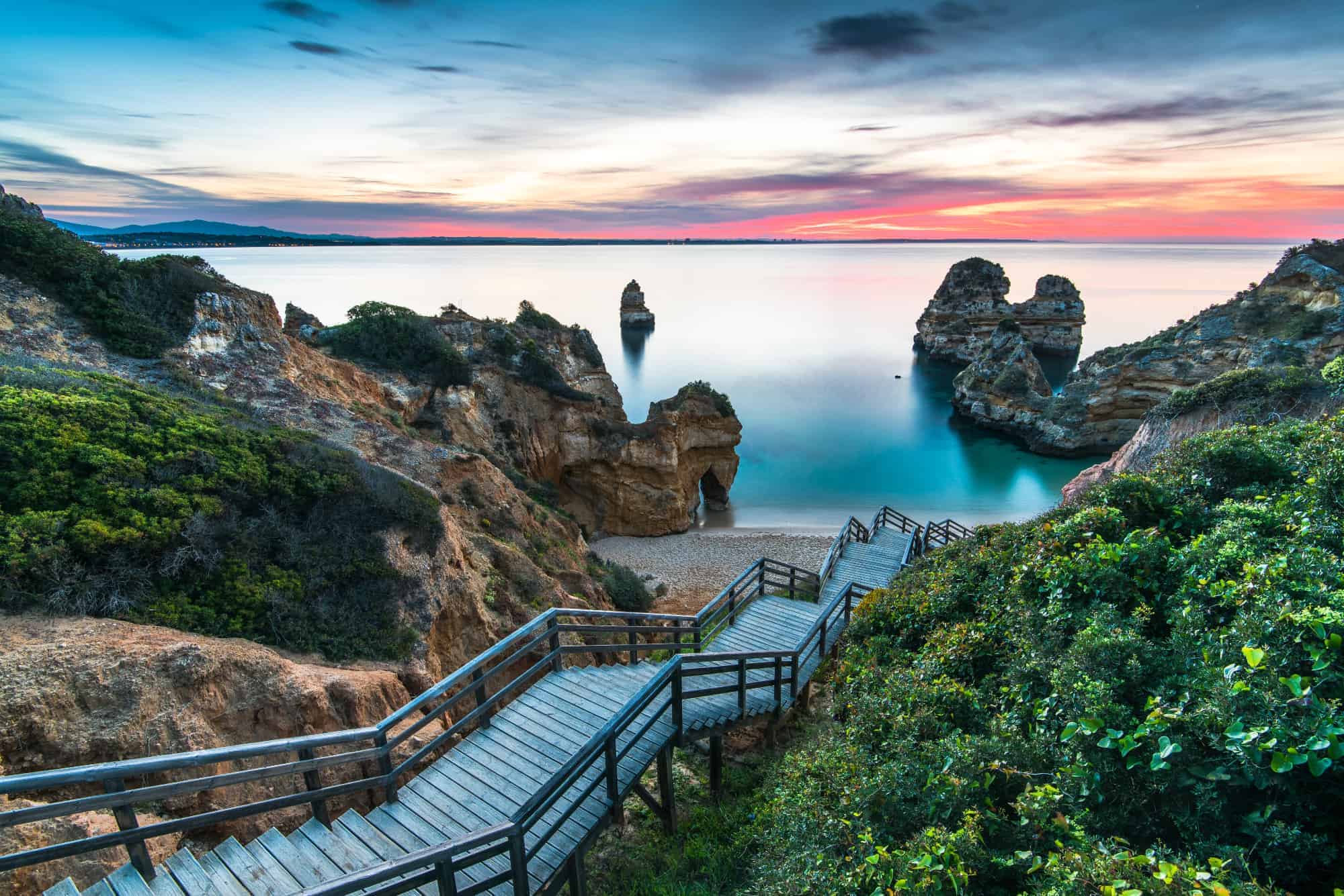 200 wooden steps down to the sheltered, sandy cove of Praia do Camilo