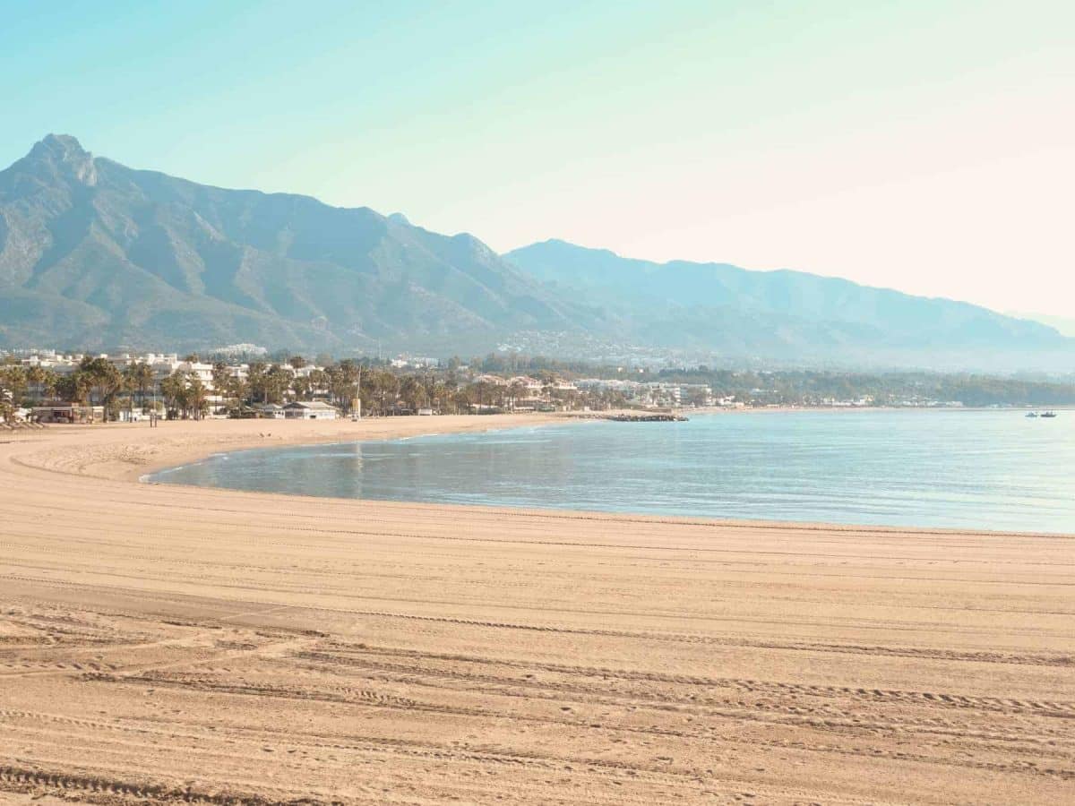 Puerto Banus beach - a silky combed stretch of golden sand framed by the sea and mountains.
