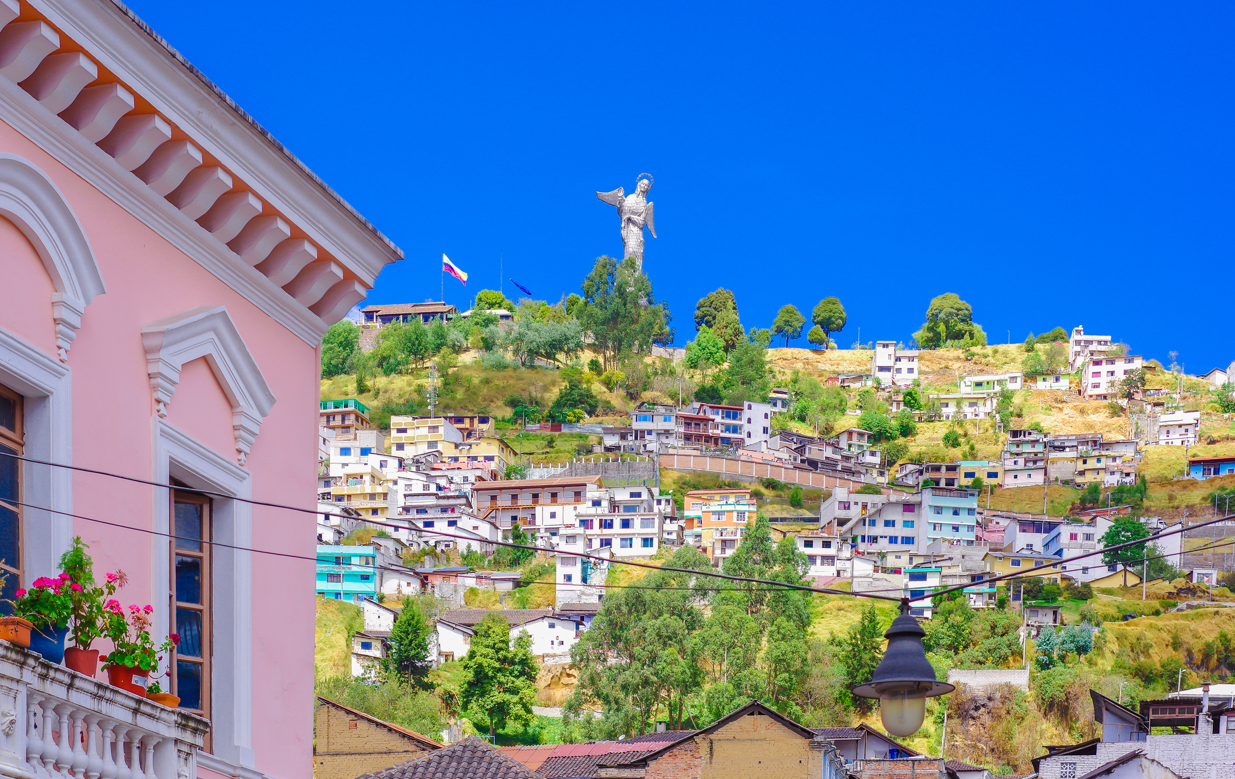 An impressive panoramic view of Quito, Ecuador,  nestled in a valley surrounded by the Andes mountains. 