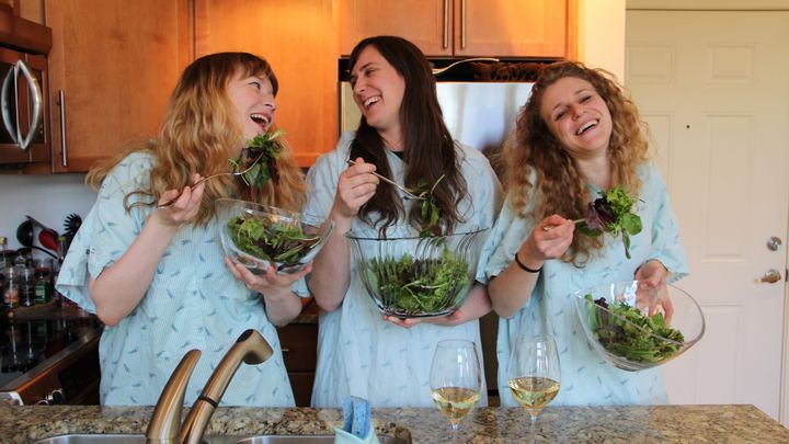 The members of Childbirth, laughing with salad (and also white wine).