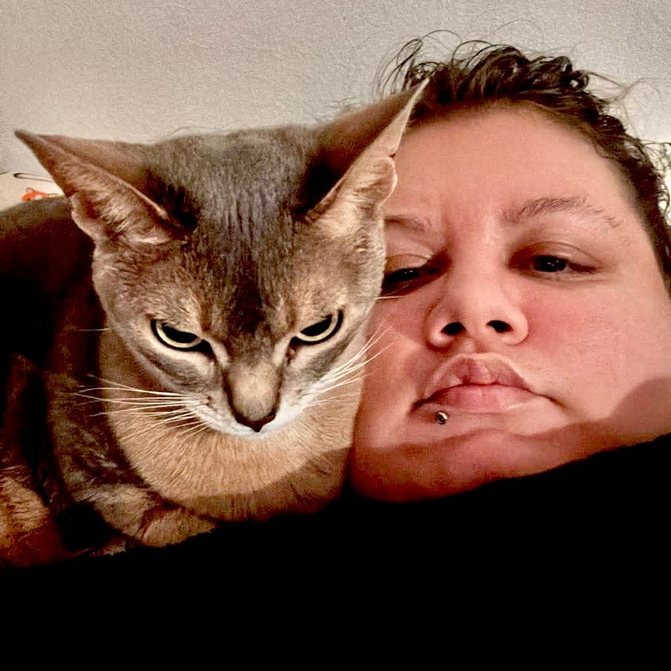 A photo of me and our cat Noomi staring seriously into the camera.