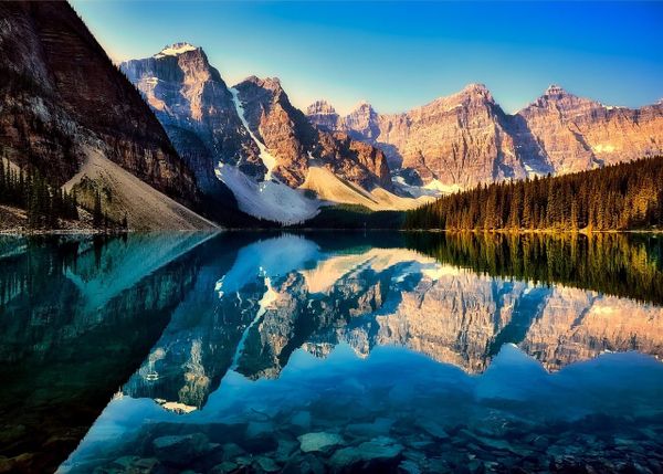 Moraine Lake and mountain peaks reflected in turquoise water