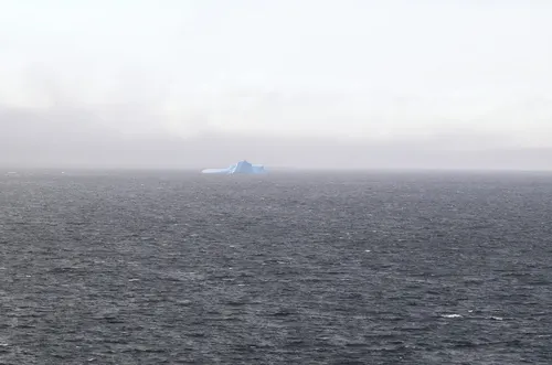 Ocean with an iceberg in the distance.