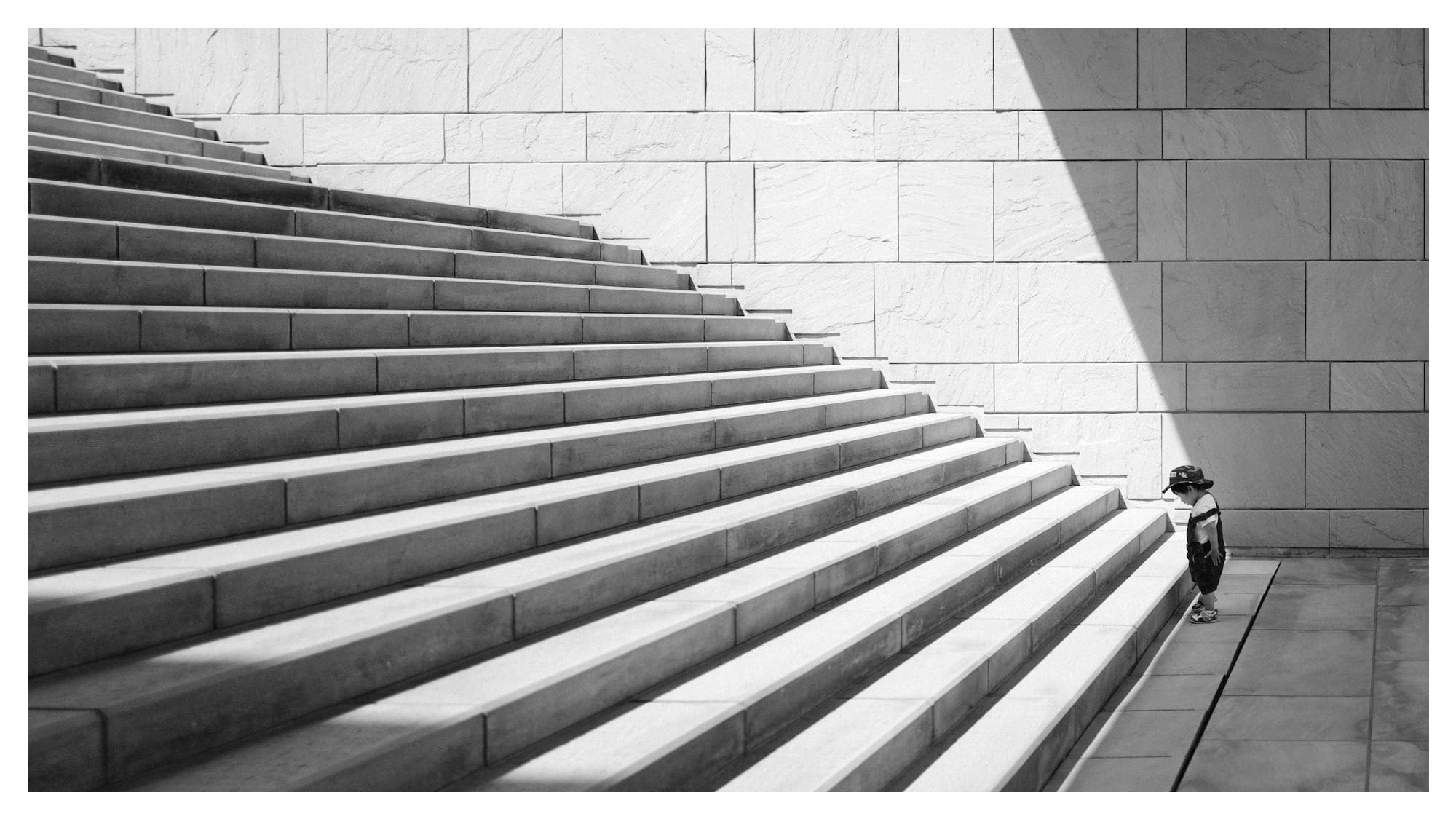 toddler's standing in front of beige concrete stair