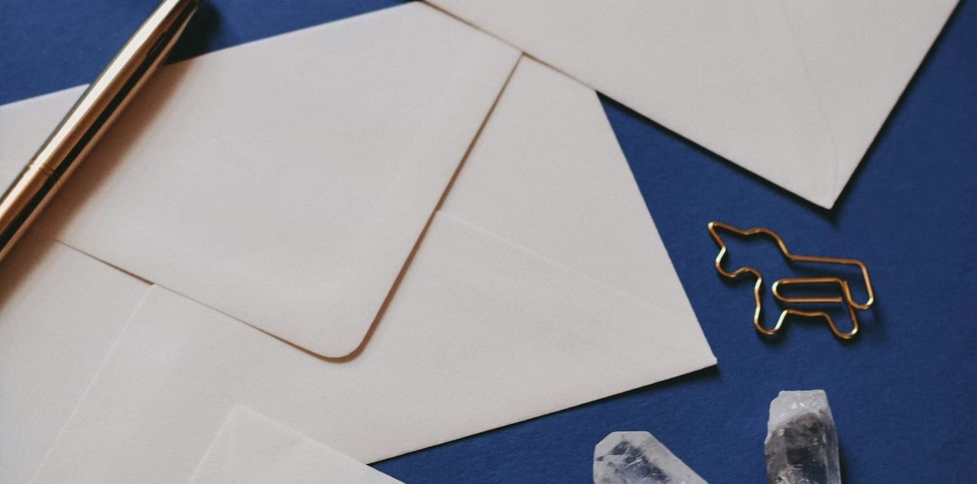 white letters on a blue background with a golden pen and a donkey shaped gold paper clip