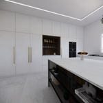 A sleek modern kitchen with tall white cabinets, built-in shelving, black double ovens, and a large island with open shelving and decorative items.
