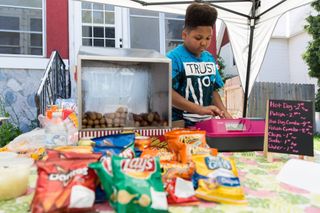 Teen entrepreneur Jaequan running his stand.