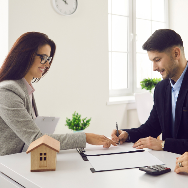Real estate investor and capital partner reviewing joint venture agreement.