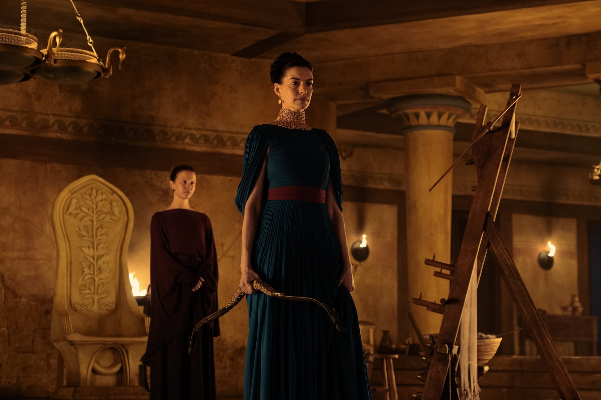 Mia Goth as Melantho and Anne Hathaway as Penelope in The Odyssey.