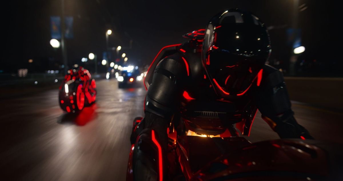 Lightcycles race through city streets in TRON: Ares.