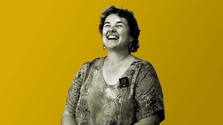 Margaret Anderson sits while laughing with a cheerful smile.