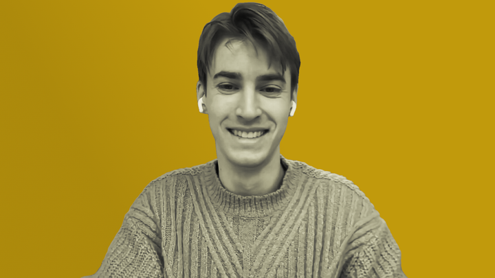 Nick Ballou smiles while sharing details of his study on grokludo.