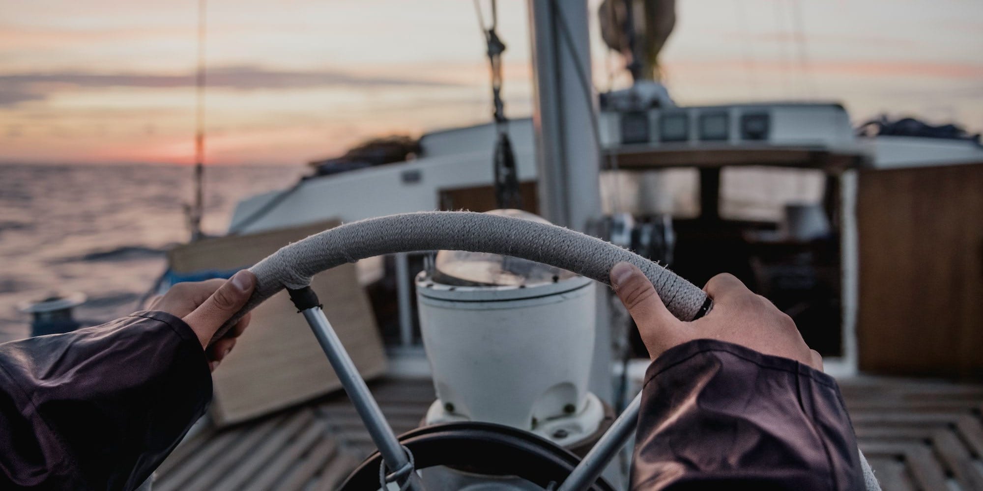 Hands steering a ship's wheel, used to illustrate governing rather than blocking new technology.