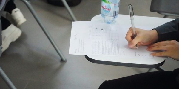 A student completing a written exam.