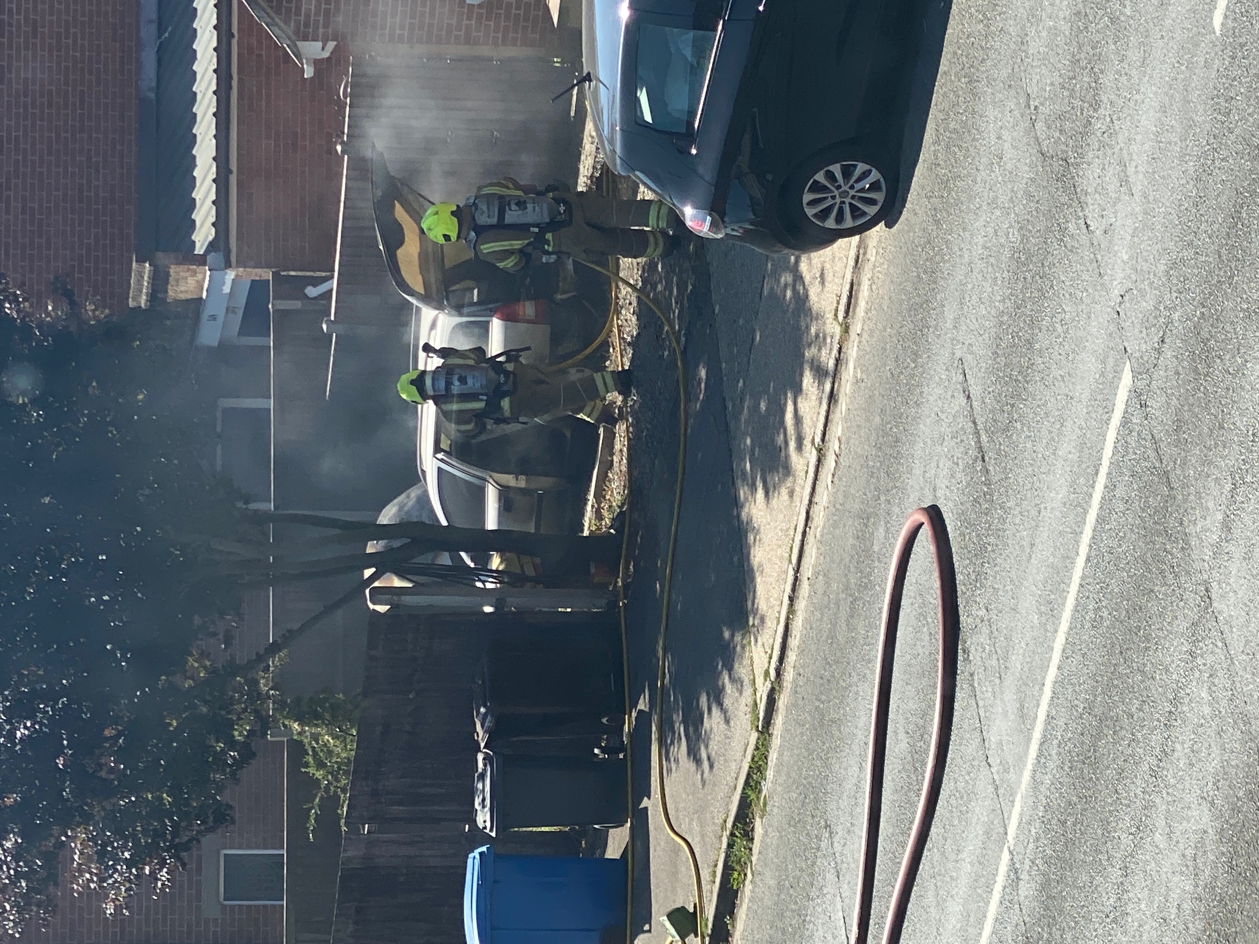 Firefighters tackle a car fire