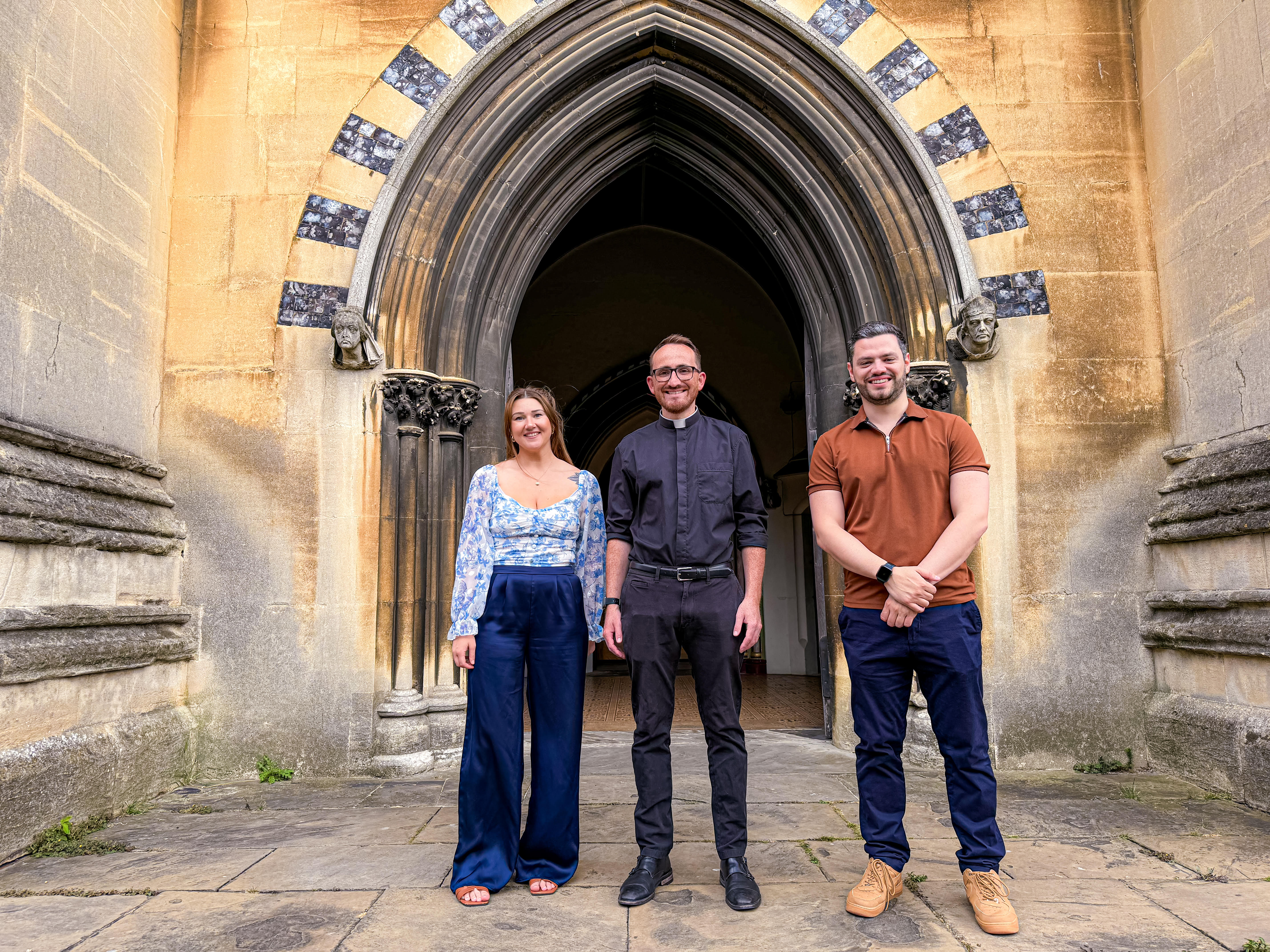 Be Peters, Tom Mumford and Jordan Bambridge in front of a church