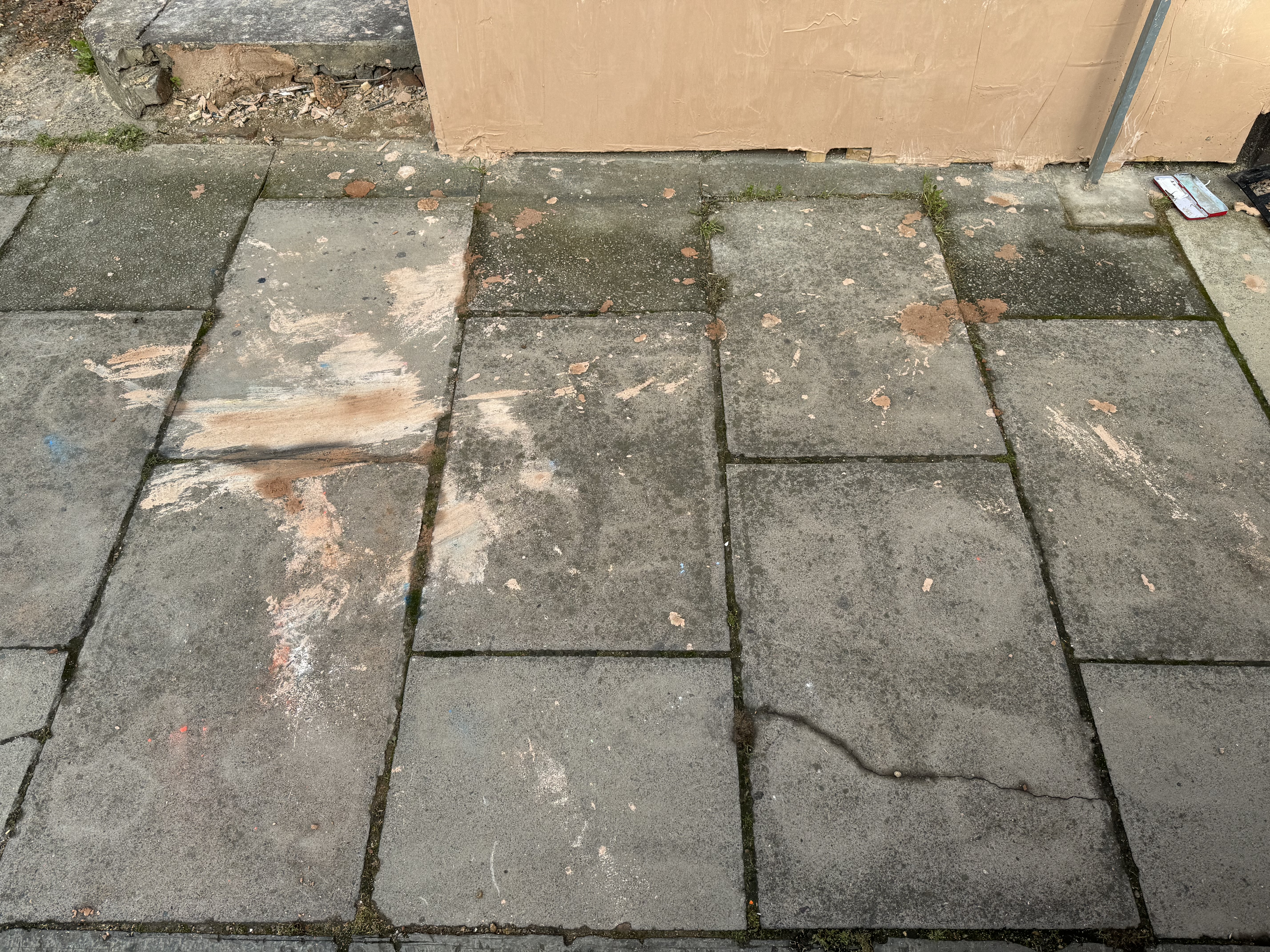 Plaster on the pavement outside the property