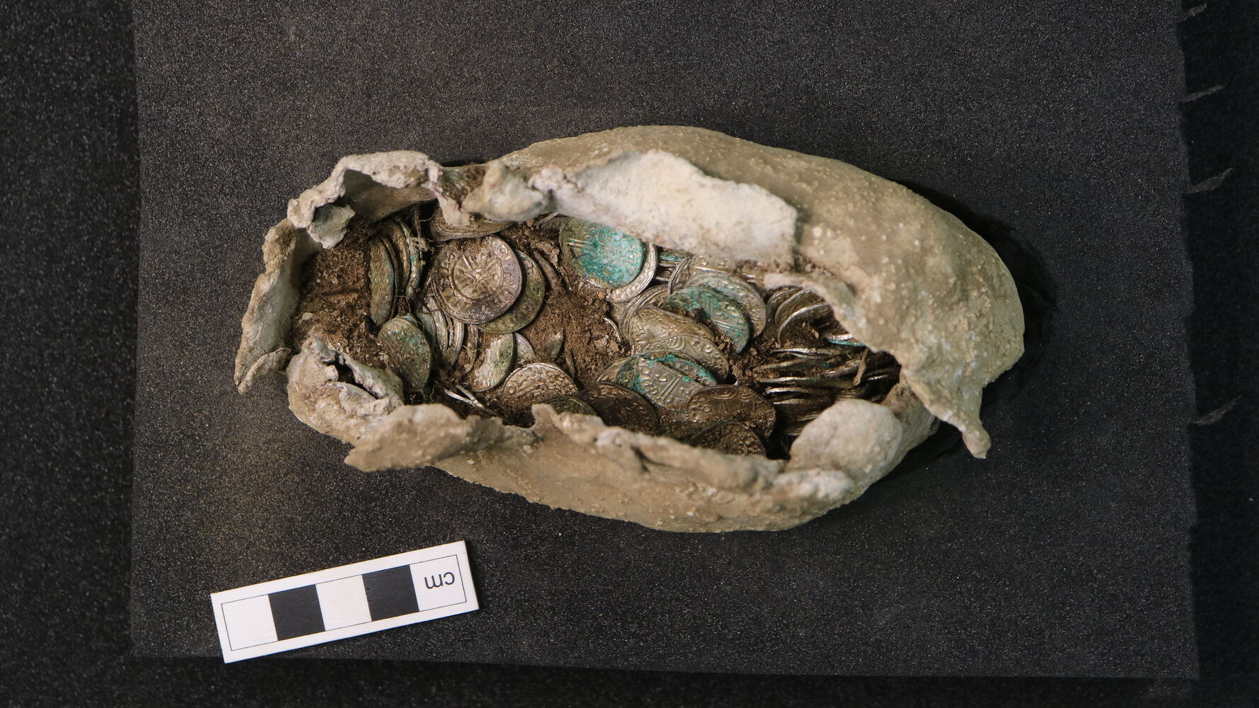 11th century silver coins wrapped in cloth and lead in a bundle