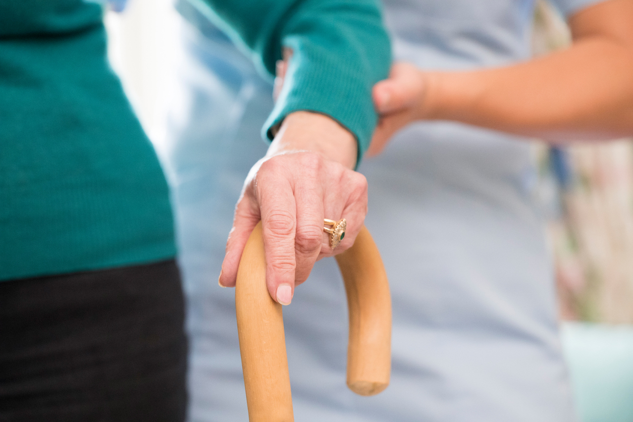 An elderly lady being assisted by an adult social care worker