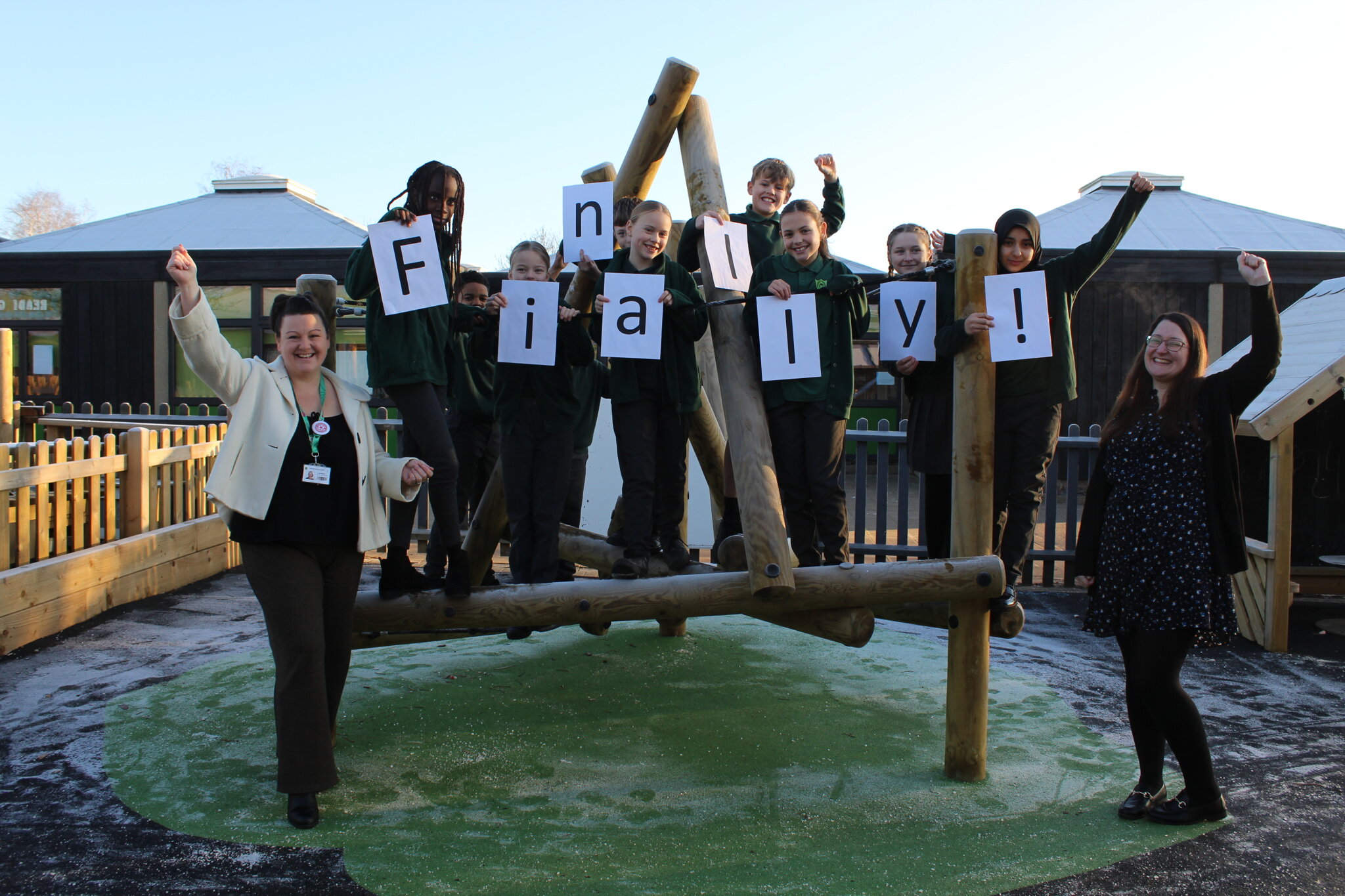 Teachers and students celebrating Gusford Primary School's Ofsted rating