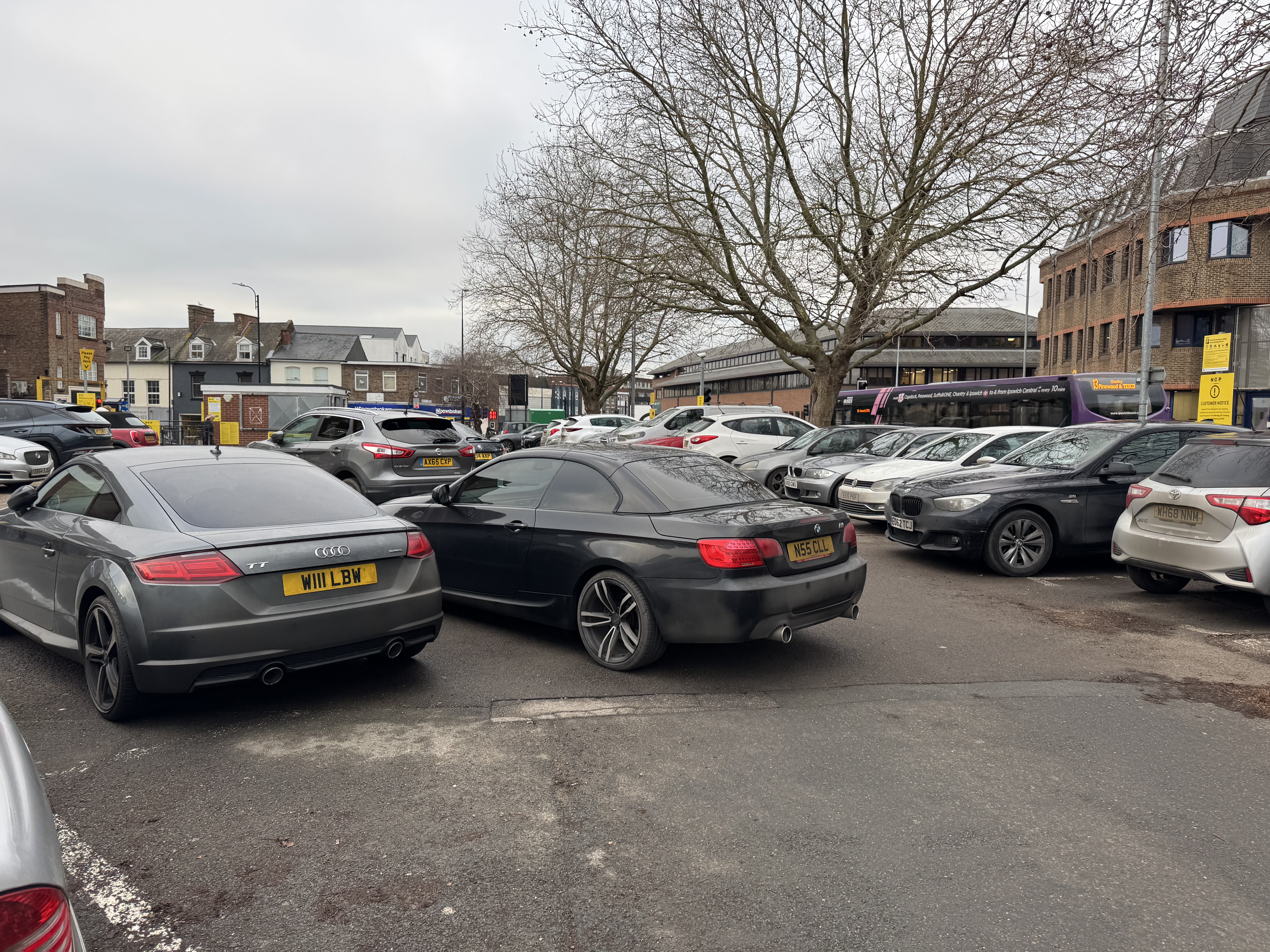 A badly parked black BMW at Tower Ramparts car park in Ipswich