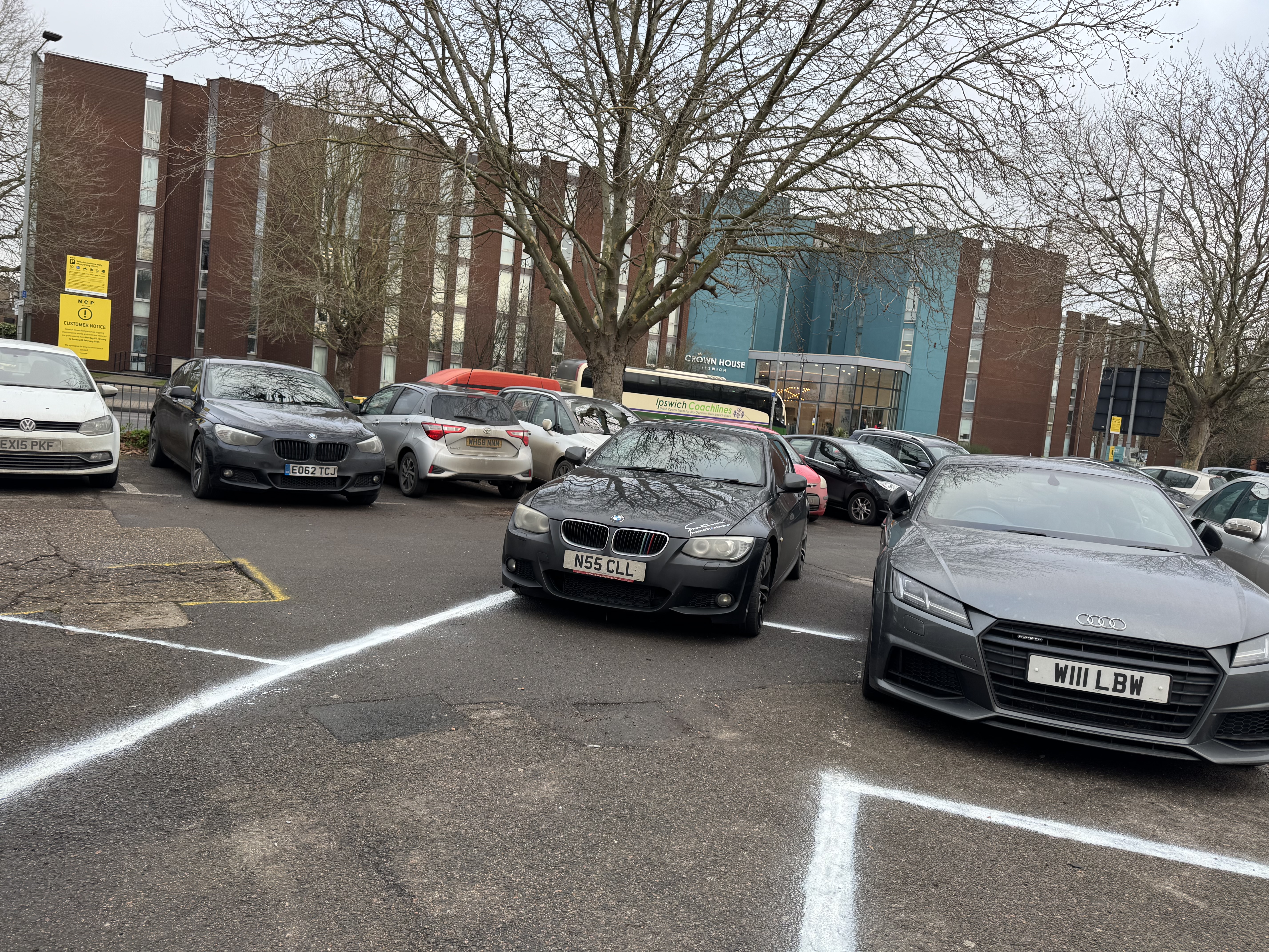 A badly parked black BMW at Tower Ramparts car park in Ipswich