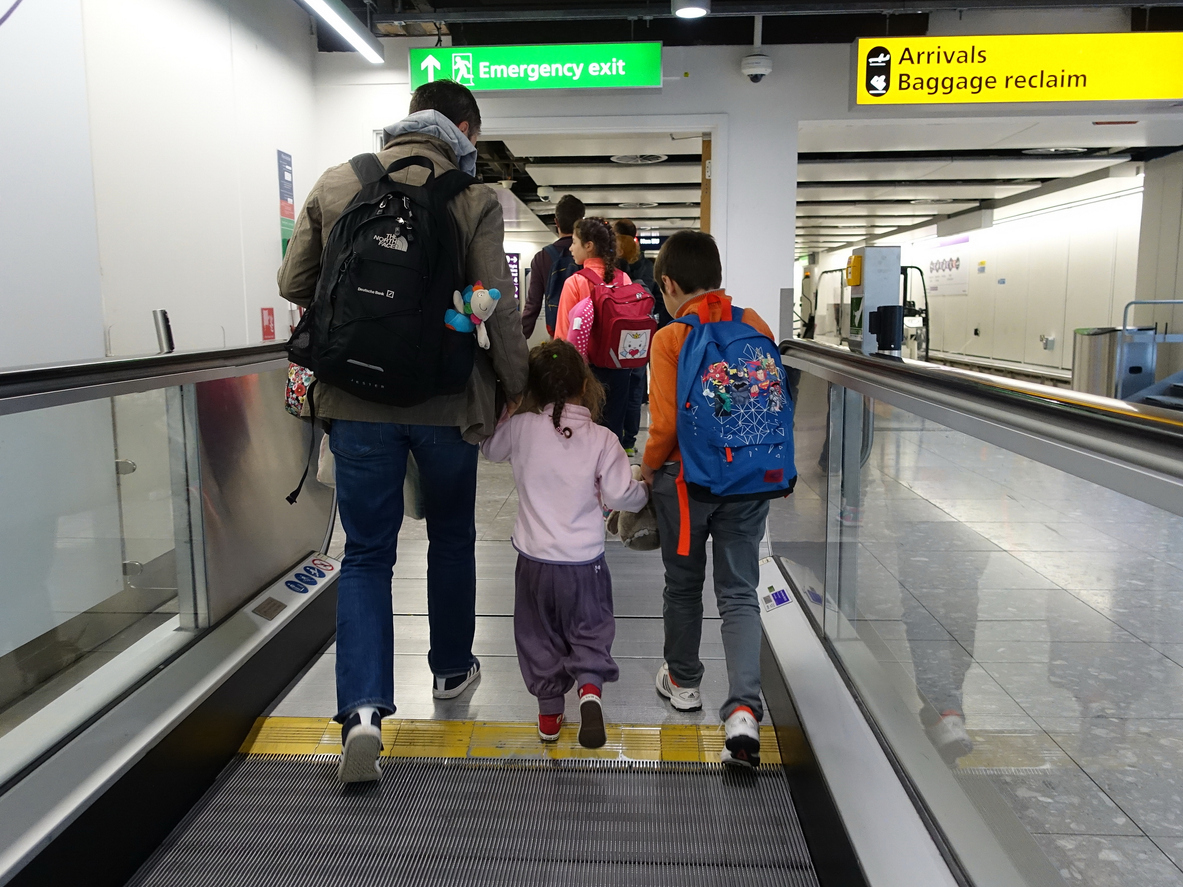A father with his two children at an airport