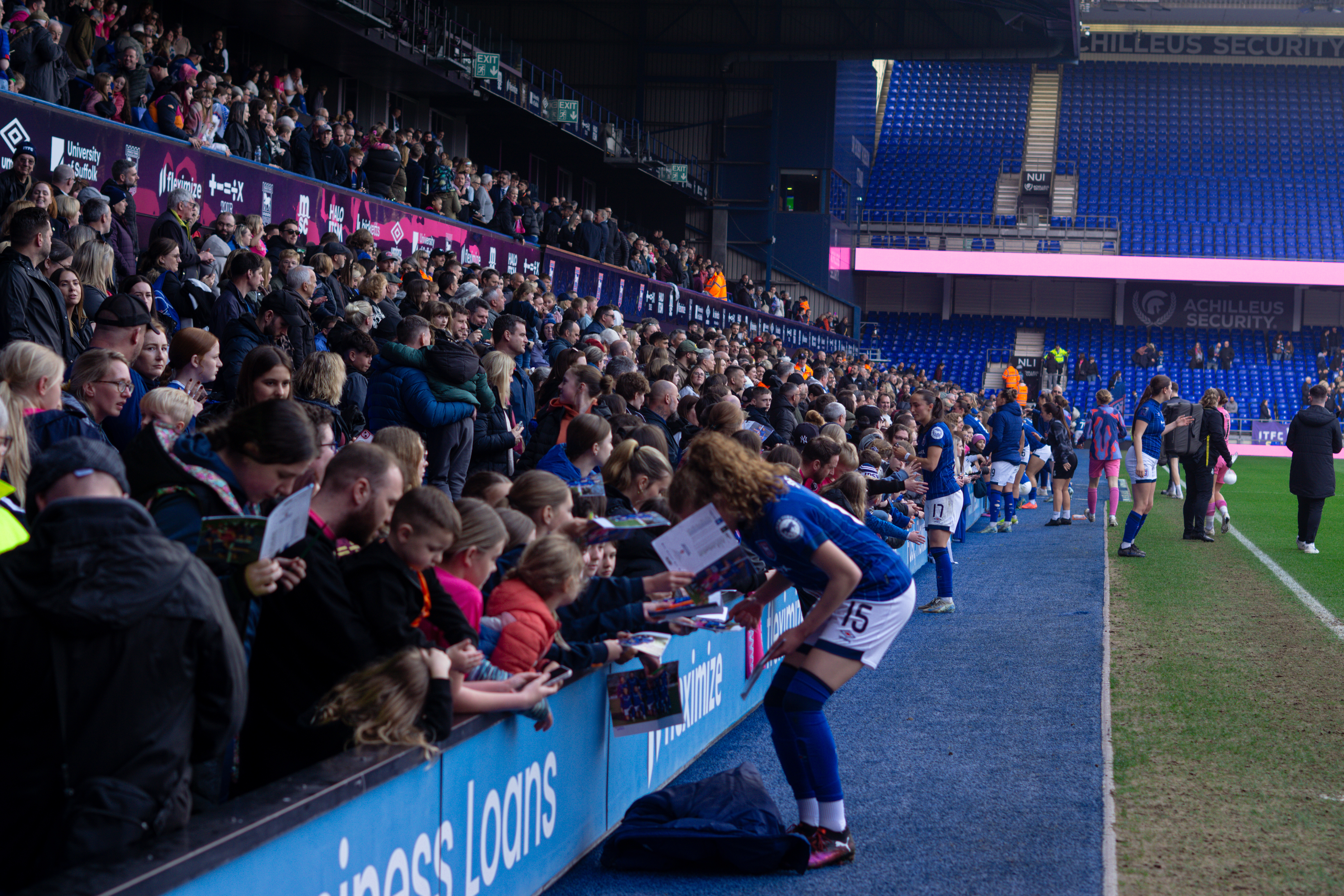 Crowds getting autographs from town player Ruby Seaby