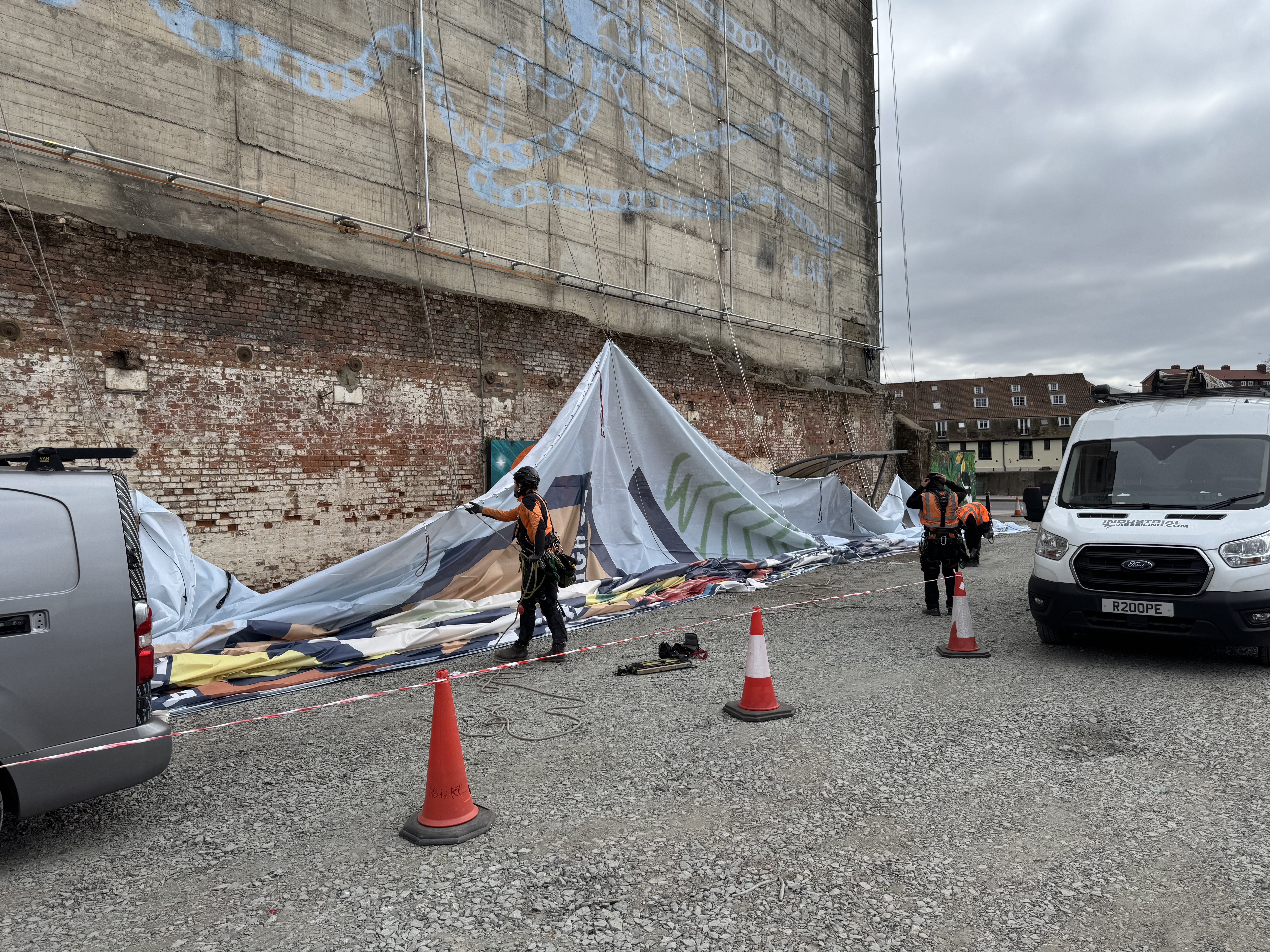 The team begin the tricky process of raising the canvas