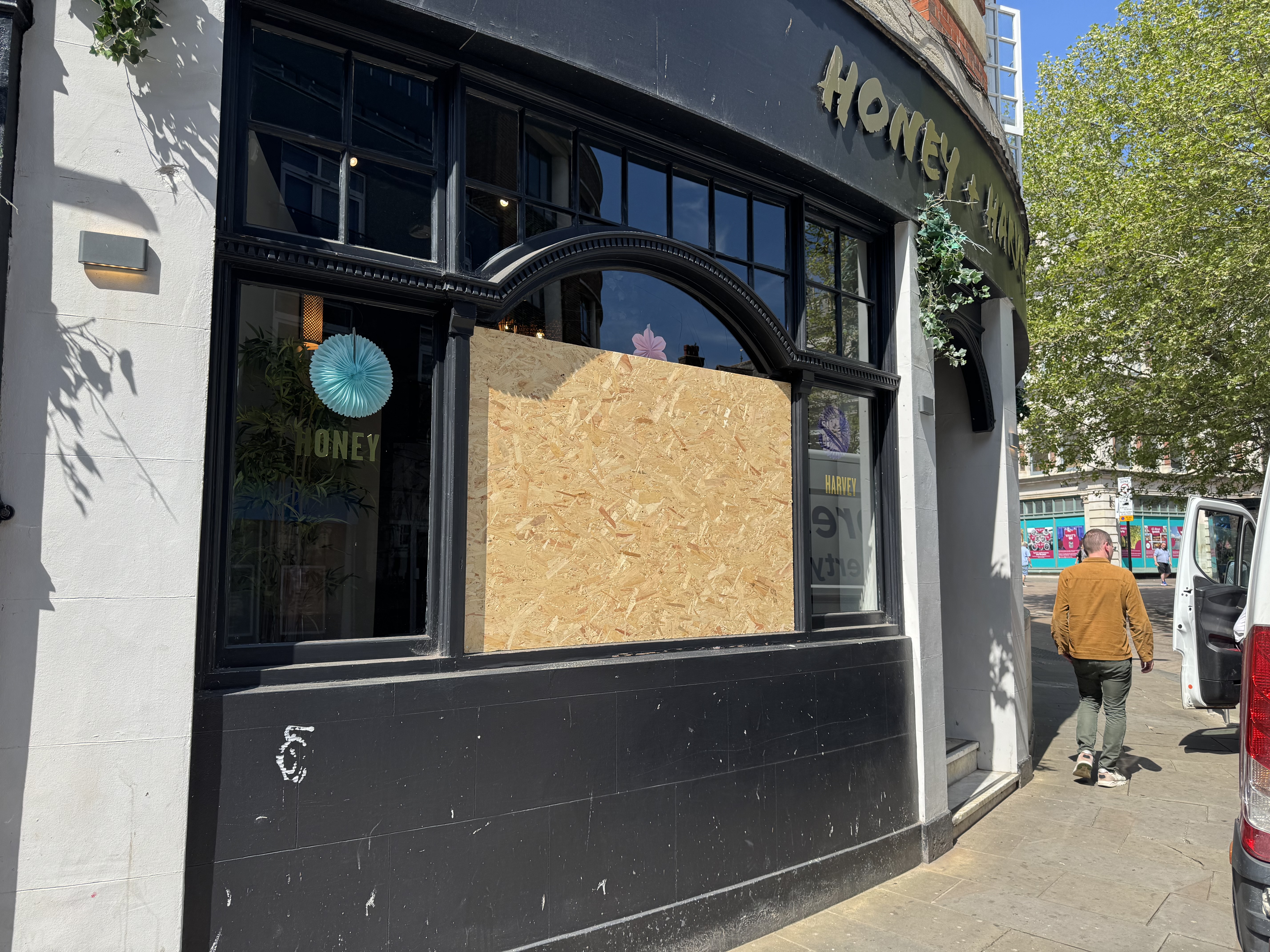 Temporary boards covered a smashed window at Honey + Harvey in Ipswich