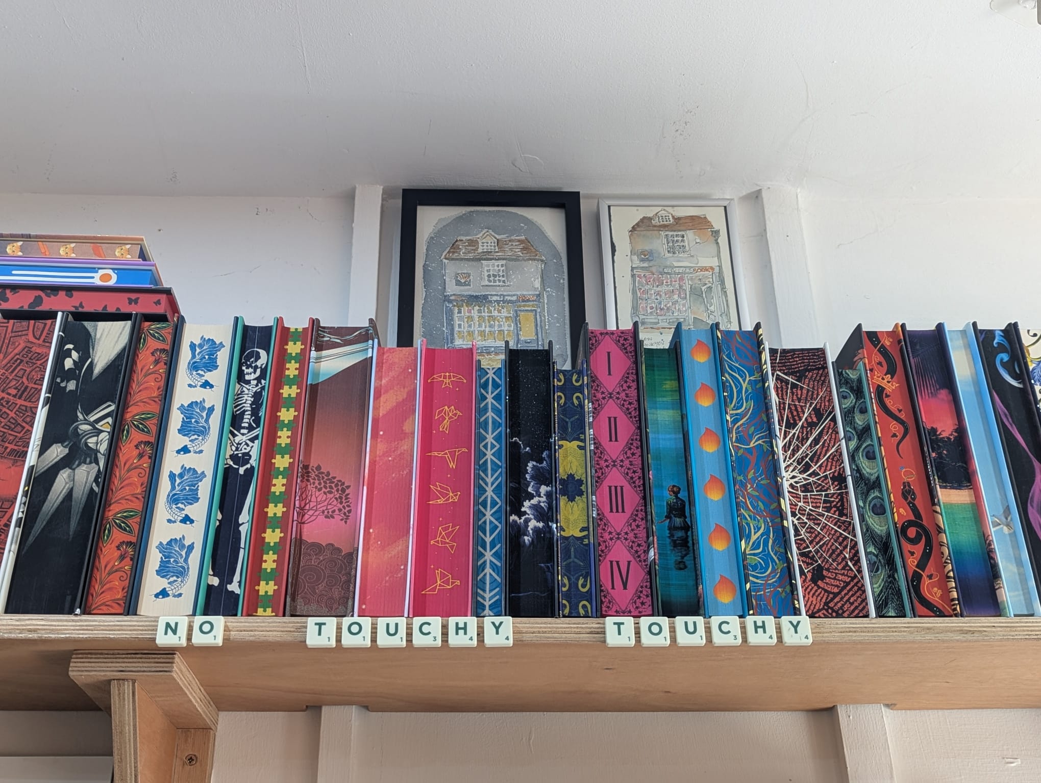 No touchy touchy sign made of scrabble pieces on the top shelf