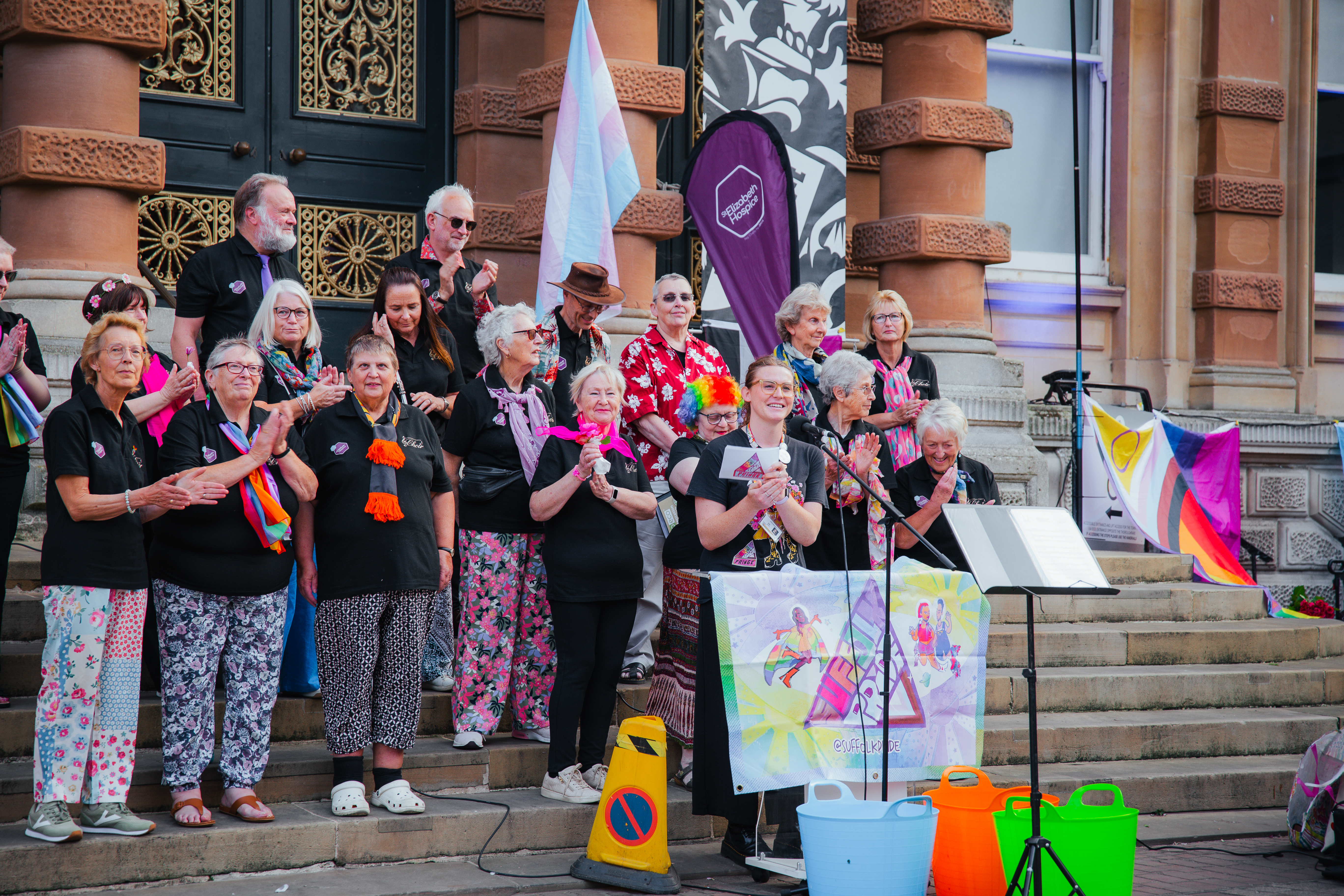 Person giving a speech on the steps of a town hall