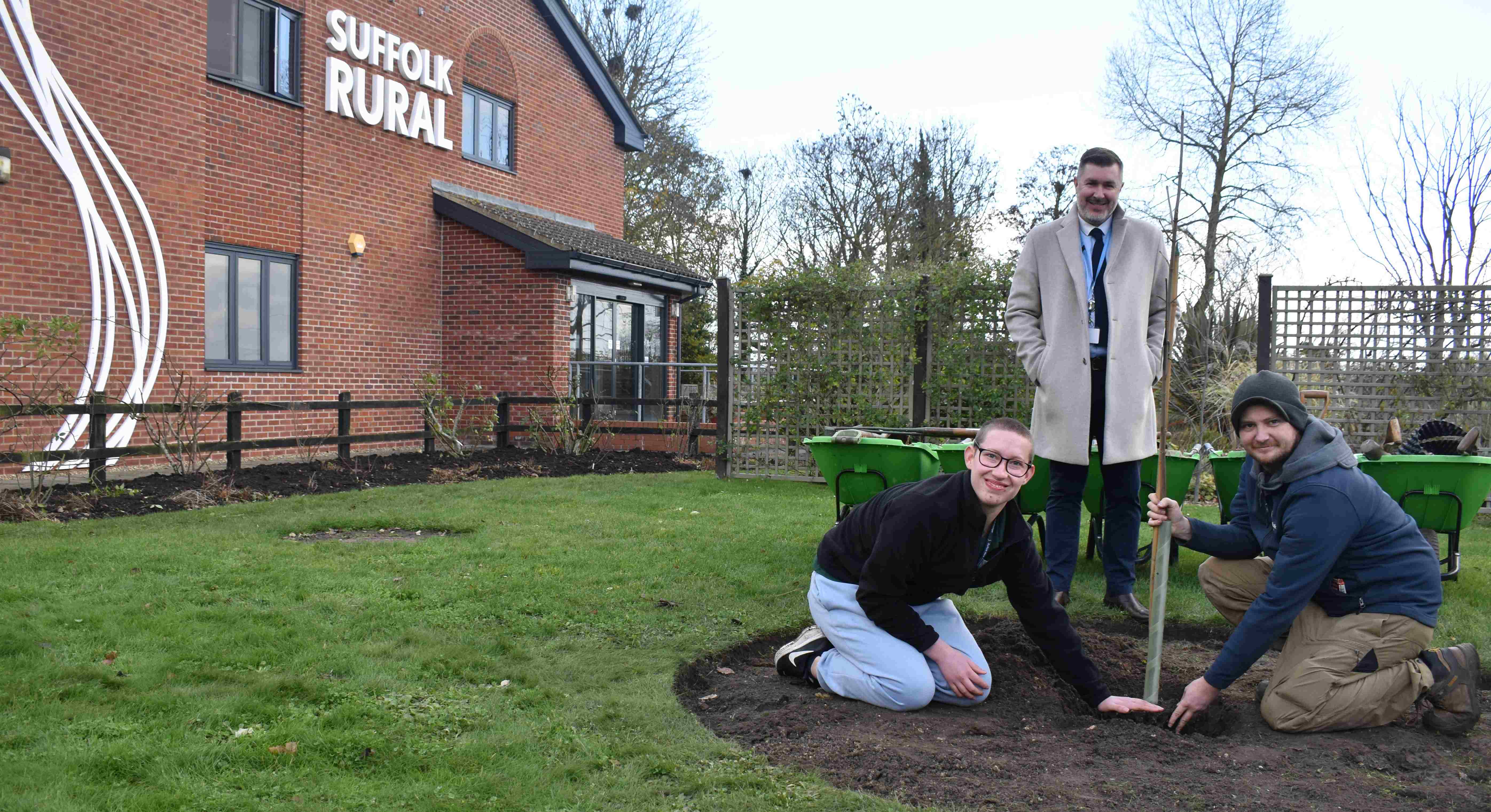 Freddie Martin and Tom Brown plant the tree of hope as principal and CEO Alan Pease looks on