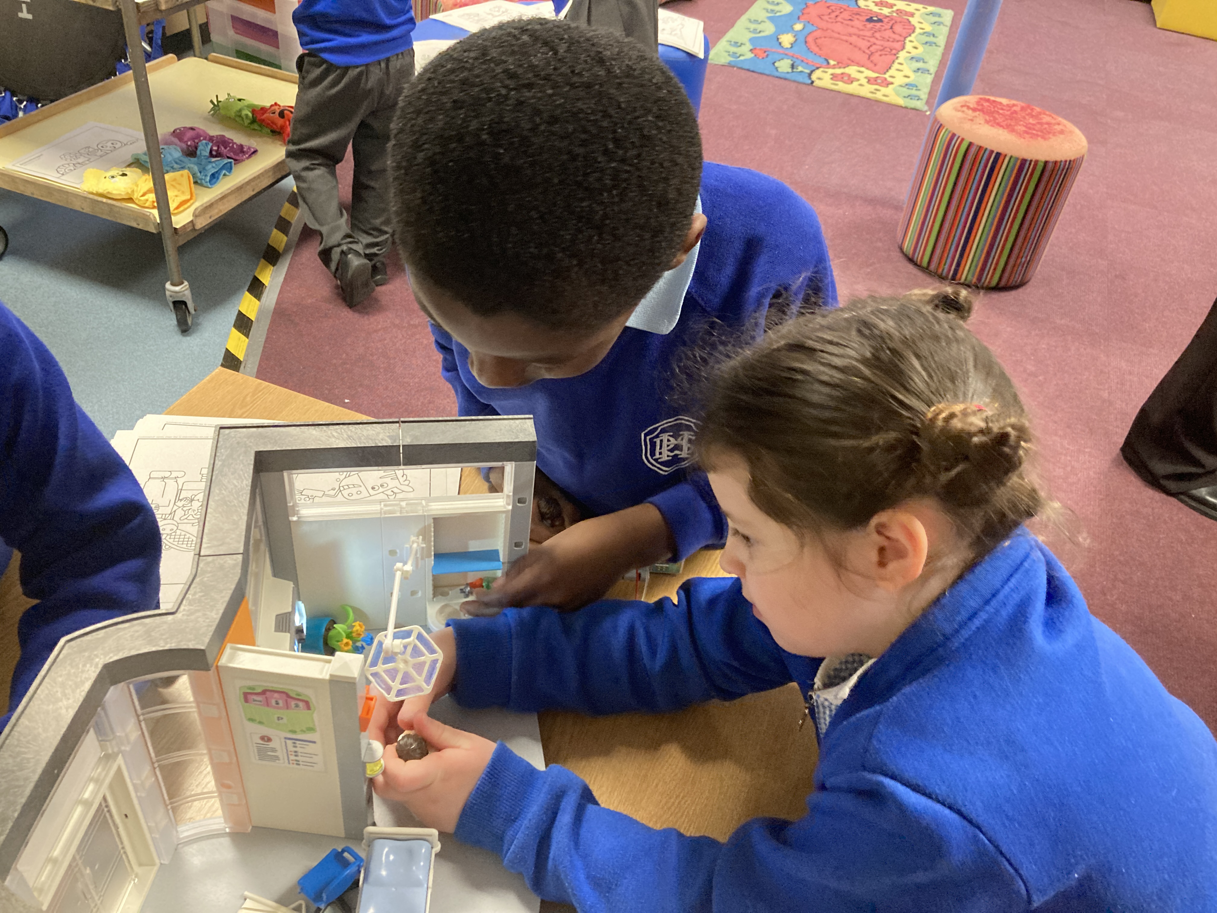 Rushmere Hall pupils Wisdom, left, and Aubrey, play with a toy operating theatre